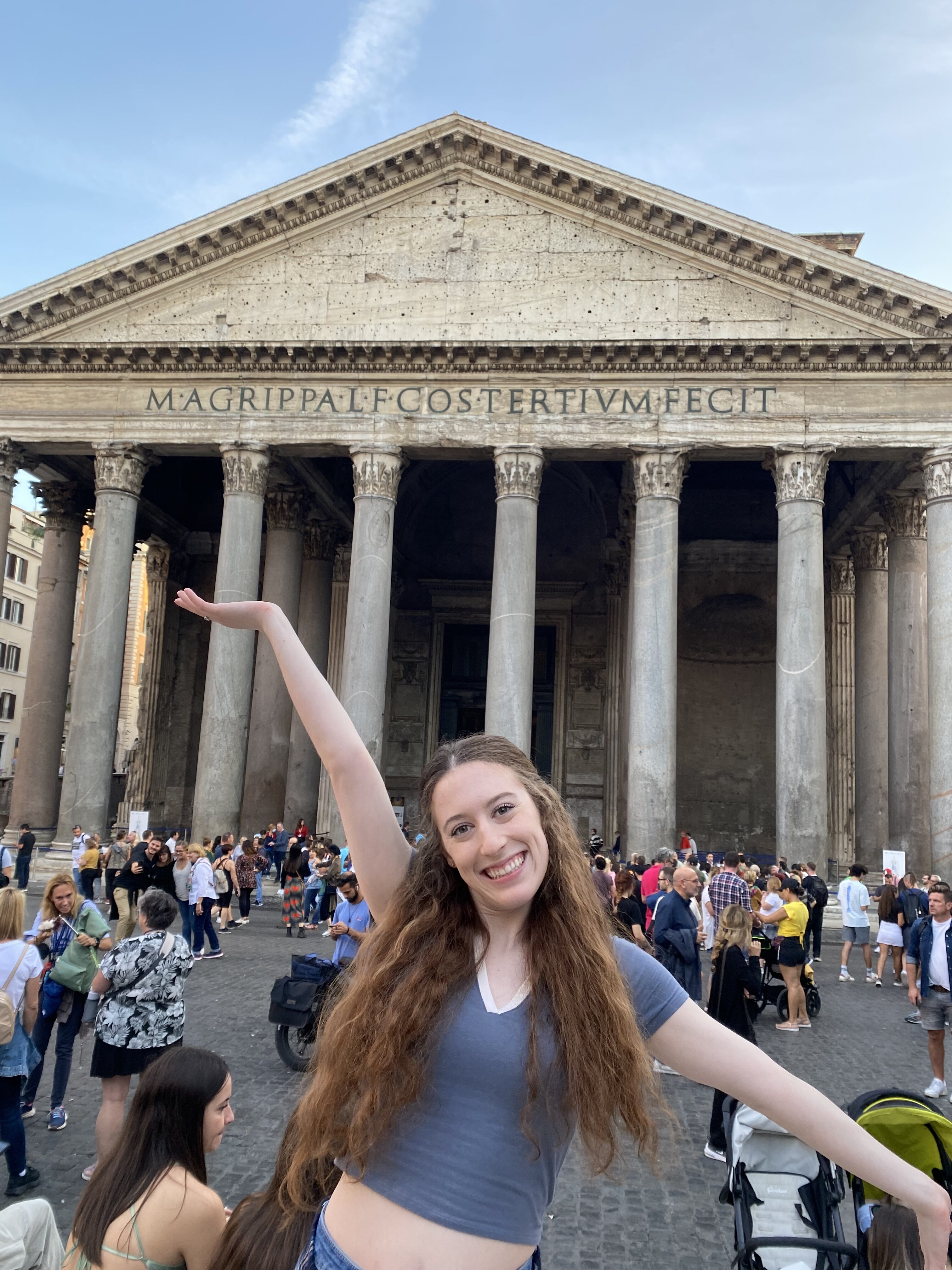 I was so in awe of this ancient structure! Bella posing with her right arm above her head, in front of the Pantheon.