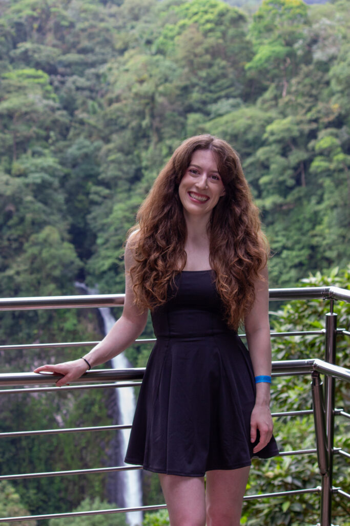 Bella, standing in front of La Fortuna Waterfall (Costa Rica)