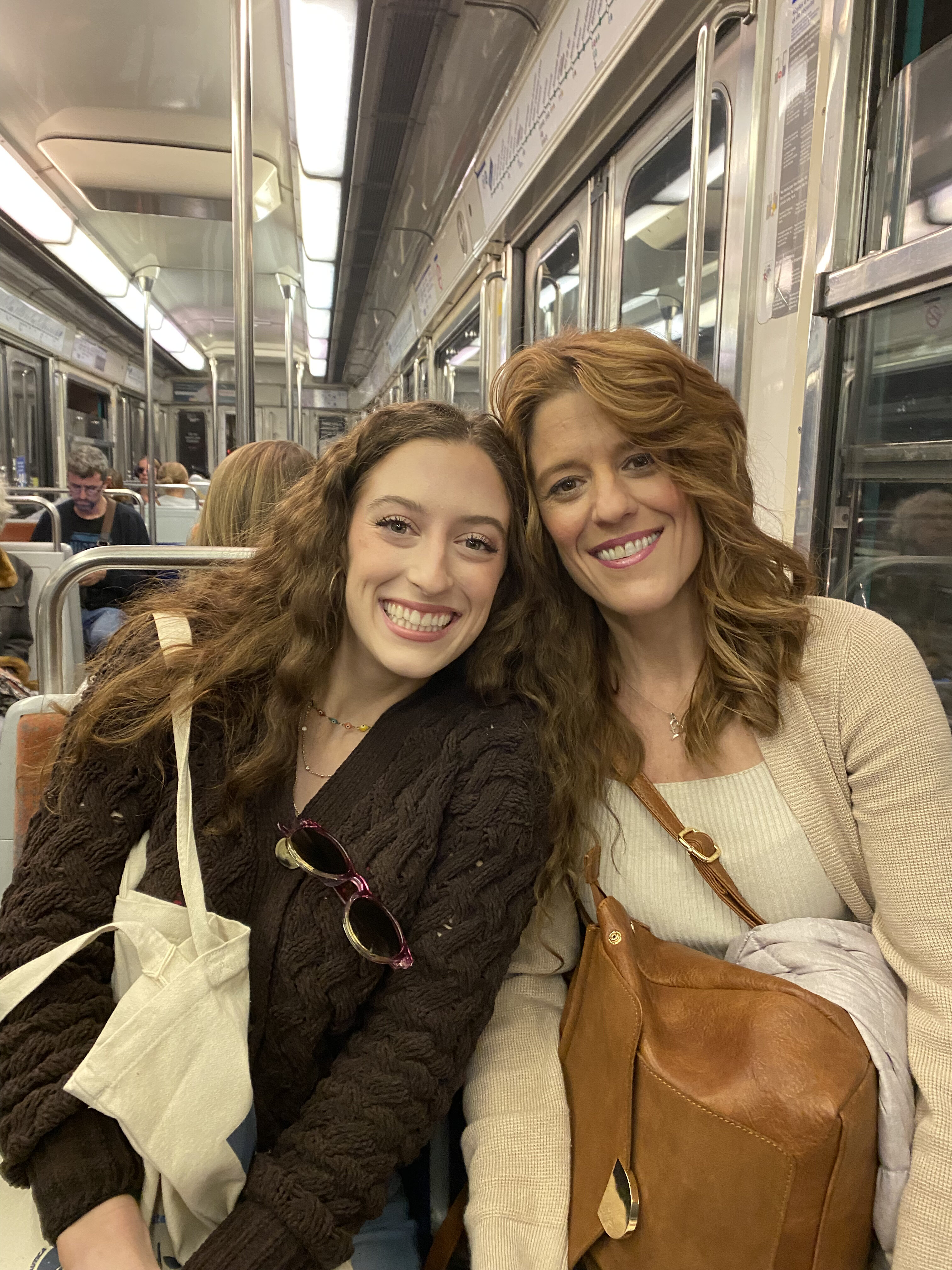 Bella's twin sister, Lily, and her mom on the Paris Metro.