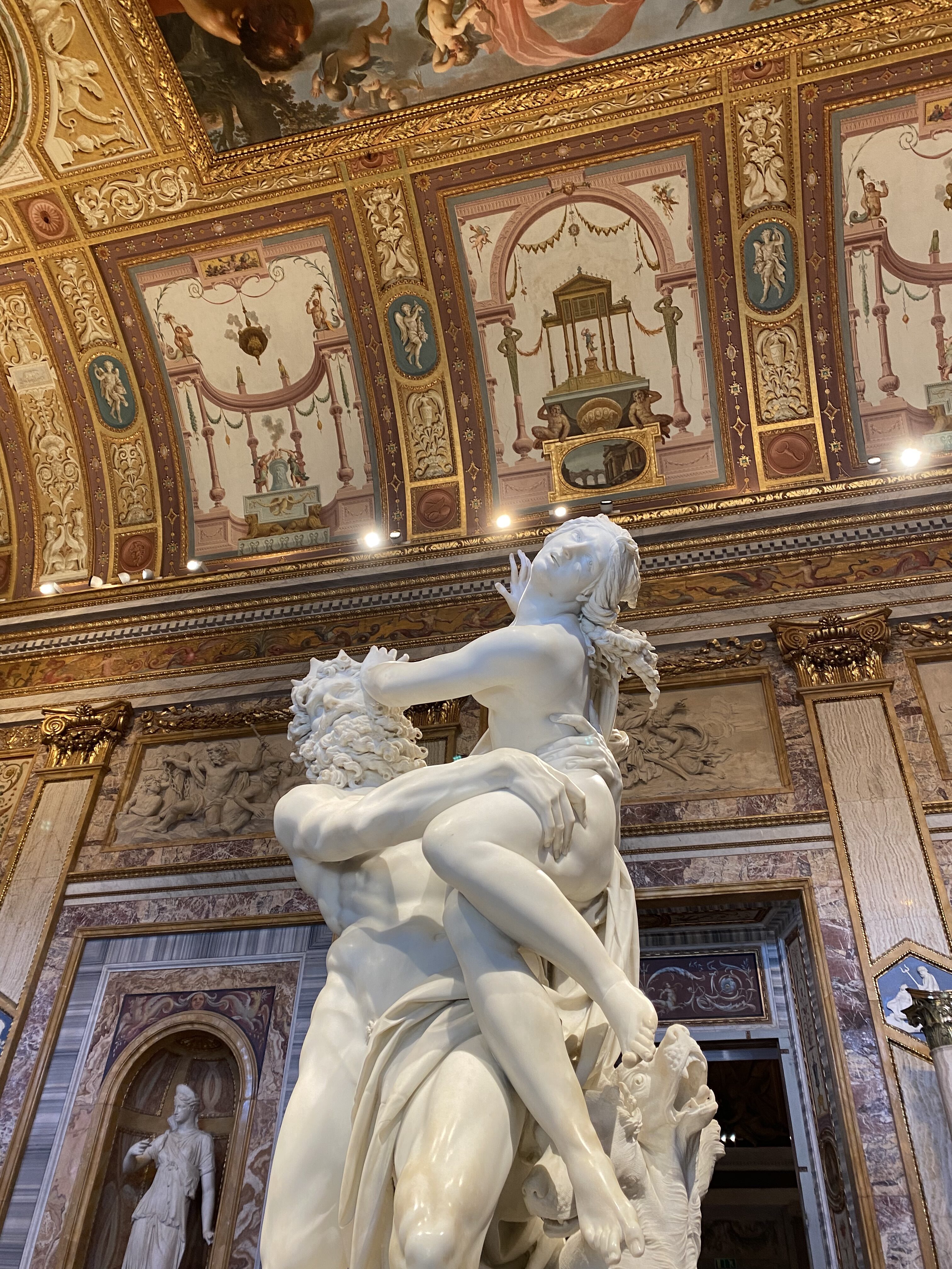 This is my favorite sculpture in Galleria Borghese! A Carrara marble statue by the artist Bernini depicting a woman (Persephone) struggling to break from the tight grasp of a strong man (Pluto) in front of the beautiful walls of Galleria Borghese.