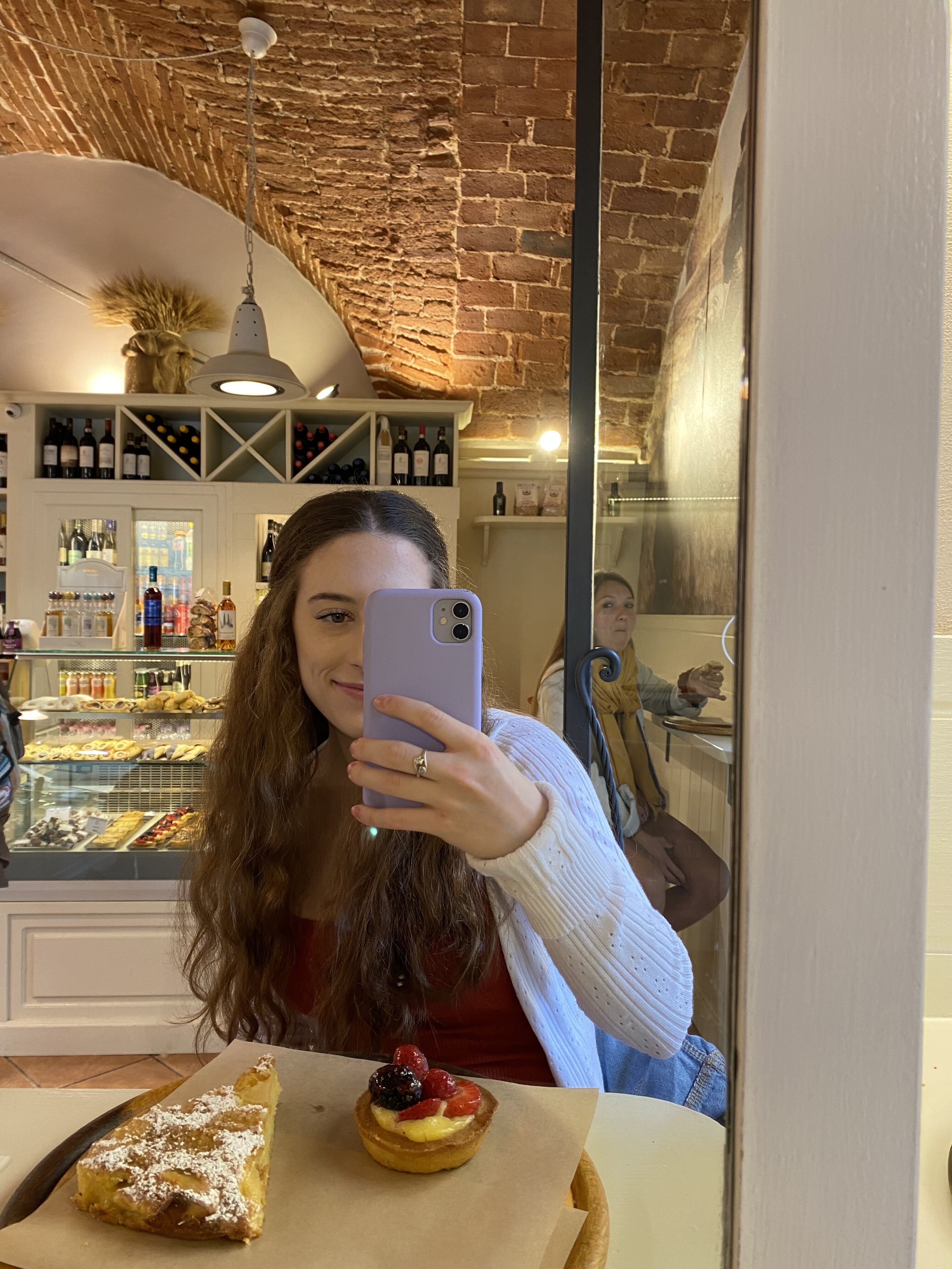 Bella taking a mirror selfie in a local pasticceria in Florence.