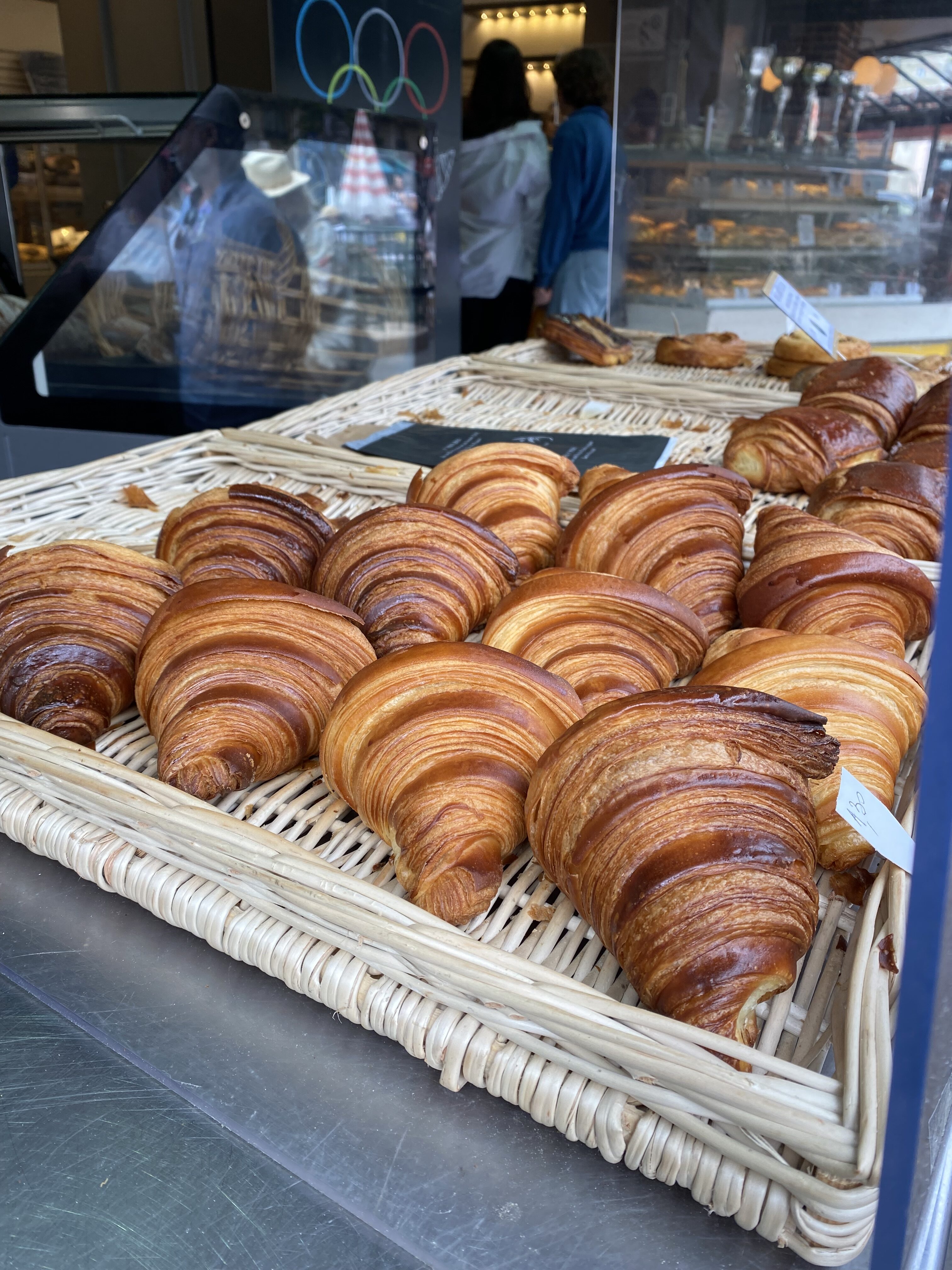 A group of flaky, buttery, golden croissants from one of the best bakeries in Paris, La Maison d'Isabelle.