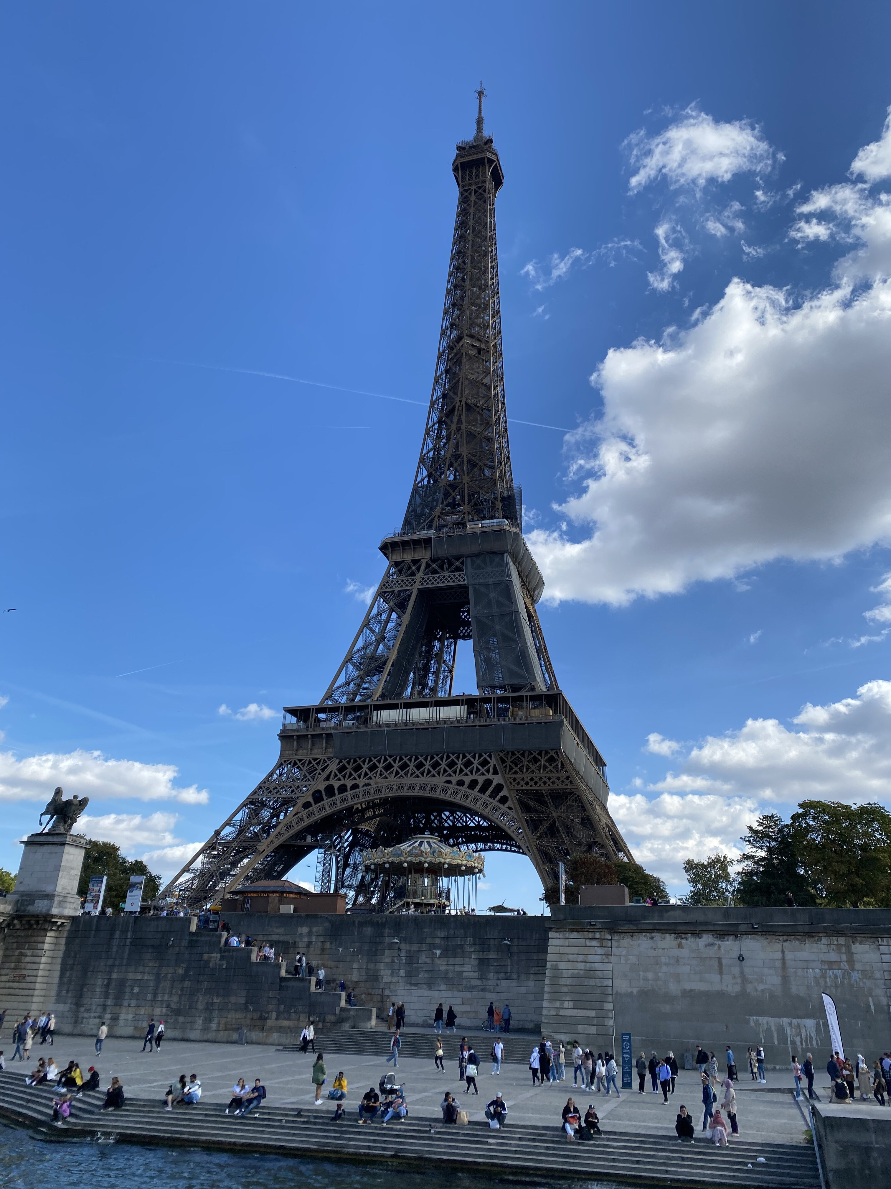 The Eiffel Tower seen from the banks of the Seine river.