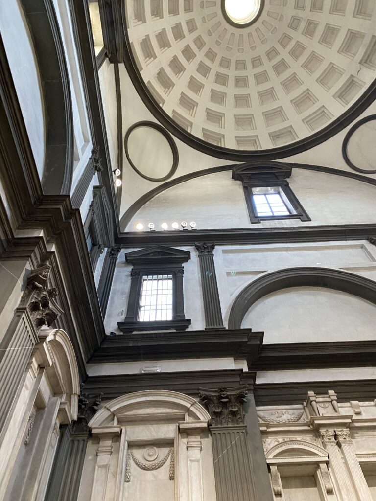 Michelangelo's New Sacristy showing the ornate ceiling and unique architecture of the walls.