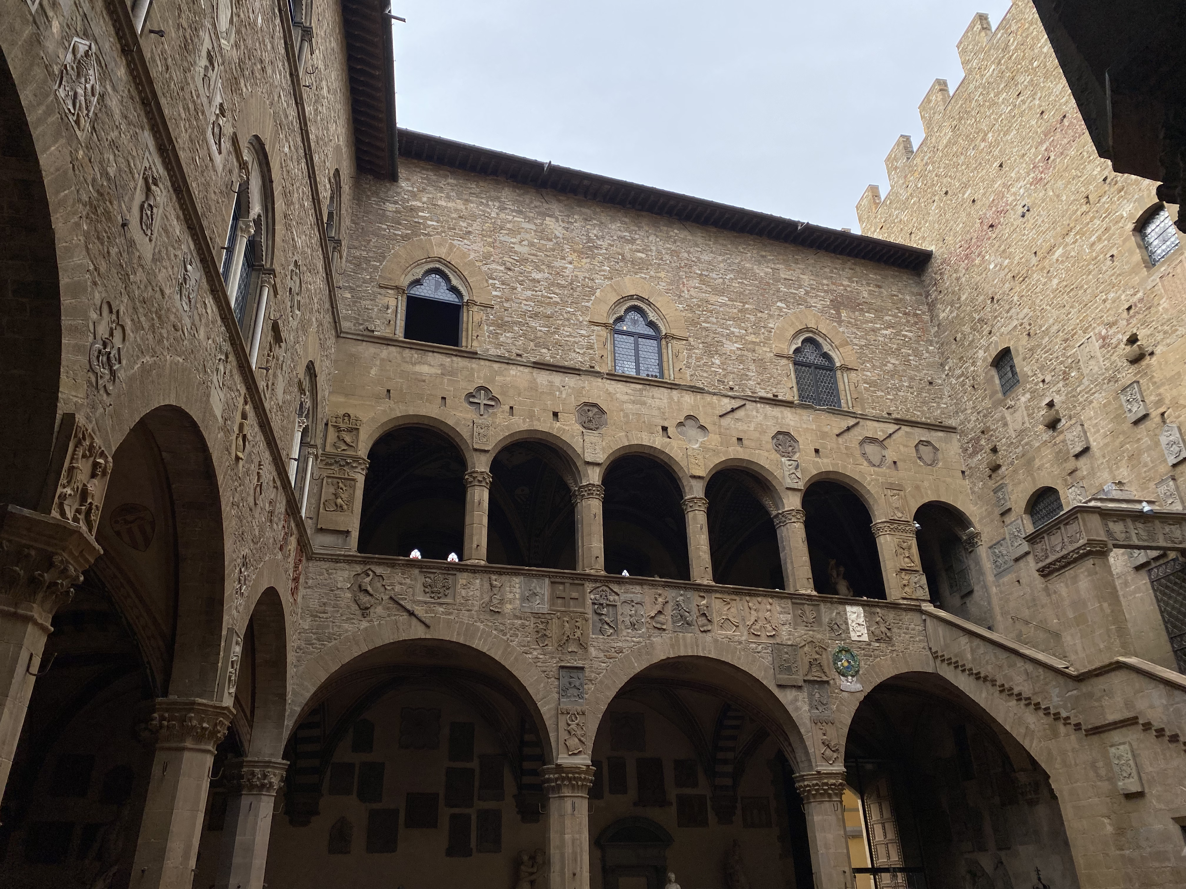 The interior of the Bargello museum which features stunning arch ways and dark stone walls.
