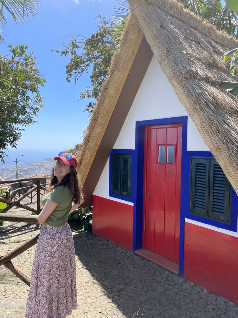 Bella posing with a Santana House with views of the Atlantic Ocean in the background.