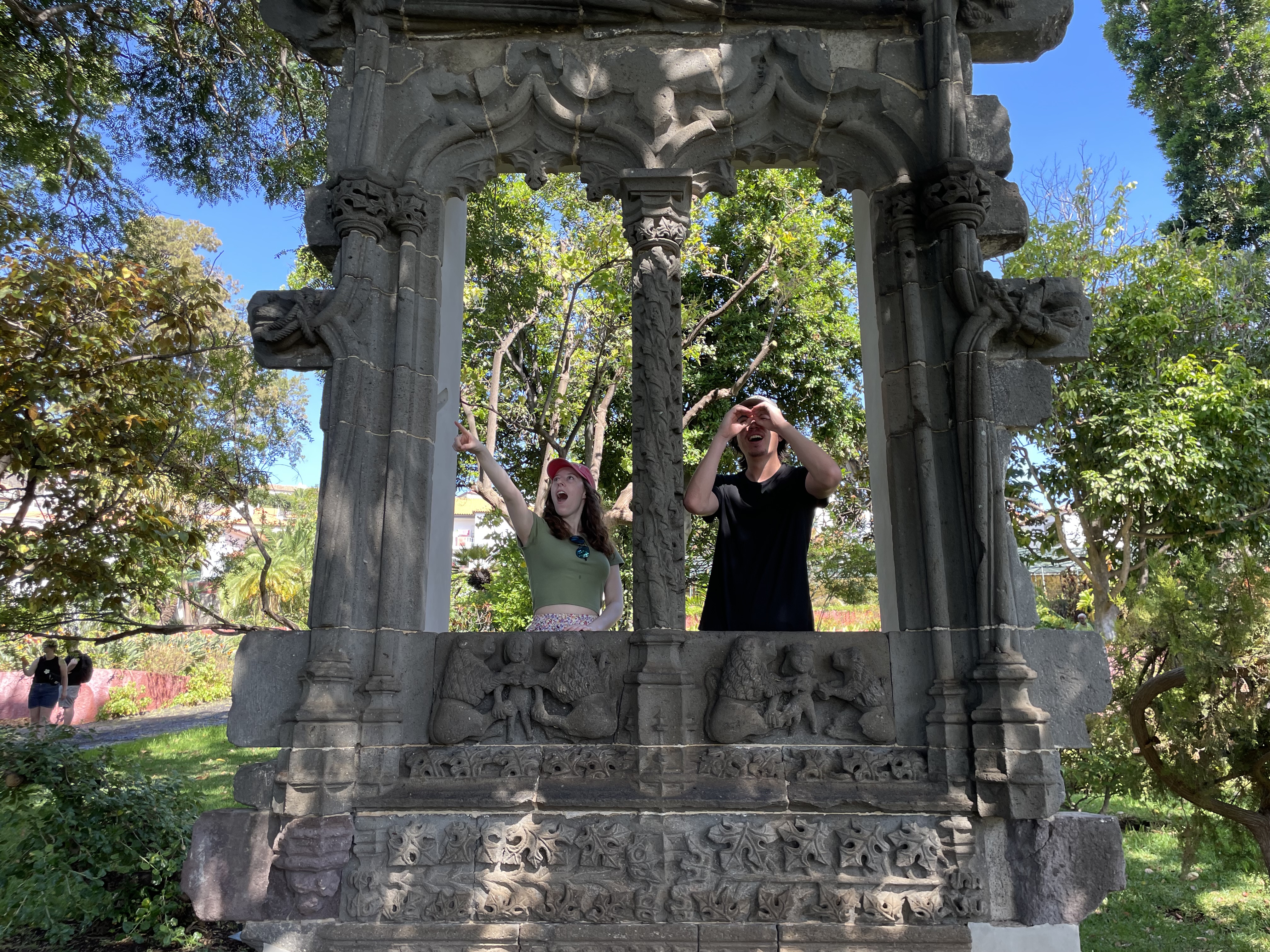 Bella and her boyfriend Sean, posing with stone architecture in a park in Funchal.
