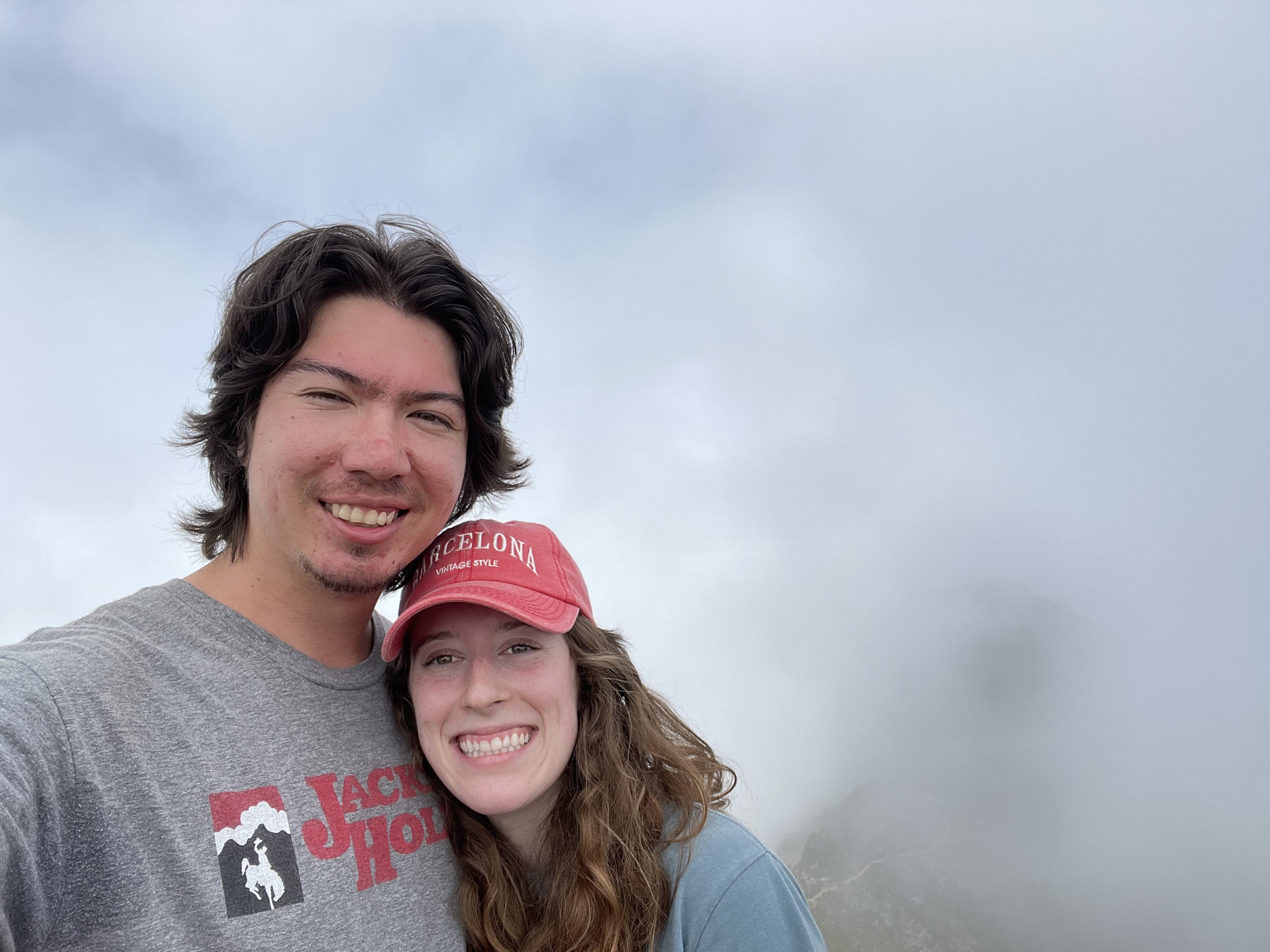 Bella and Sean (her boyfriend) smiling amidst the fog at the summit of Pico Ruivo!