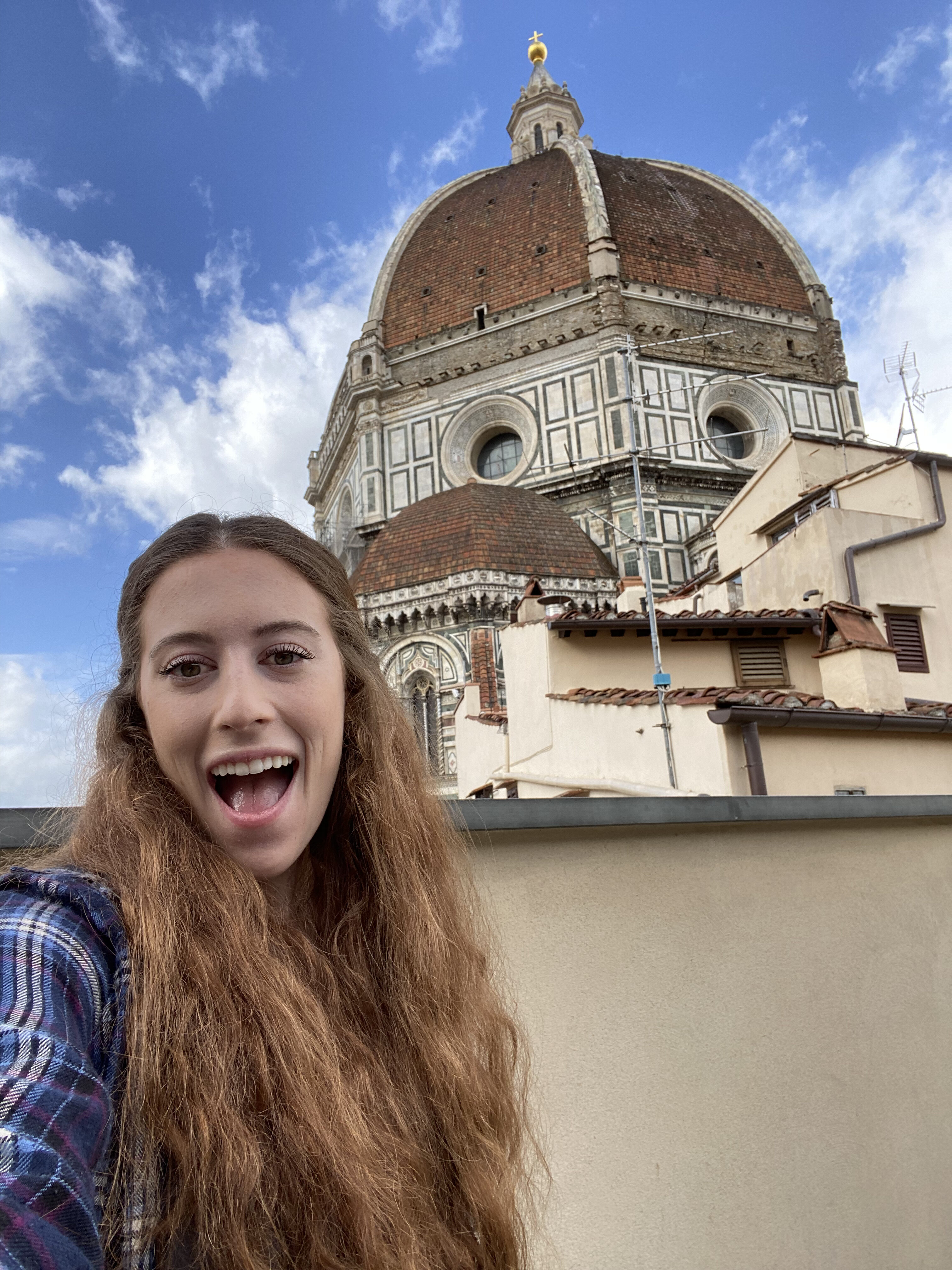 Bella posing in front of the monumental Duomo on the rooftop of Opera del Duomo Museum in Florence.