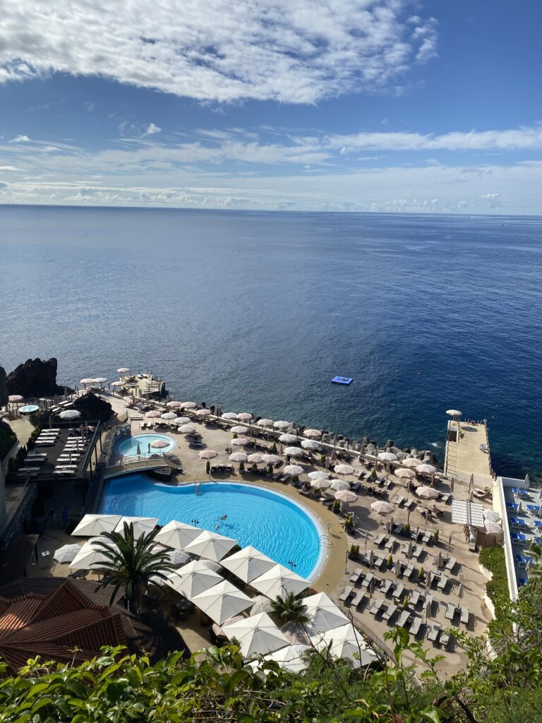 A stunning luxury resort pool right next to the sapphire ocean in São Martinho, Funchal.