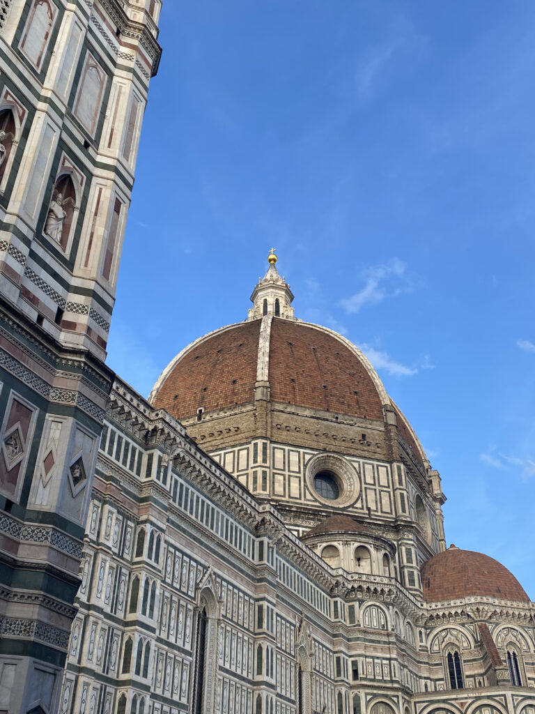 A vibrant bright blue sky illuminates the Duomo in Florence.