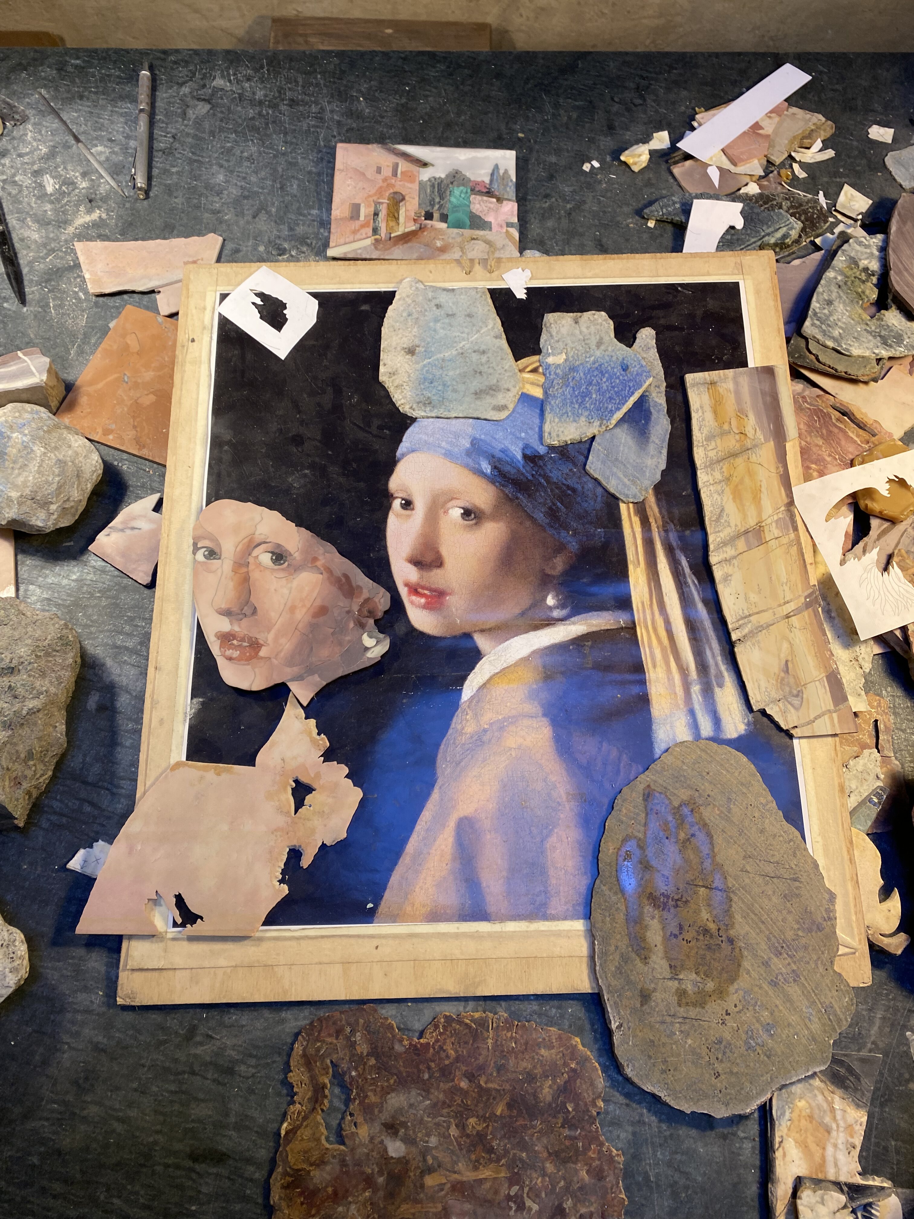A Florence mosaic using the commesso technique showing the start of a mosaic fashioned after the artwork, Girl with the Pearl Earring by Johannes Vermeer.