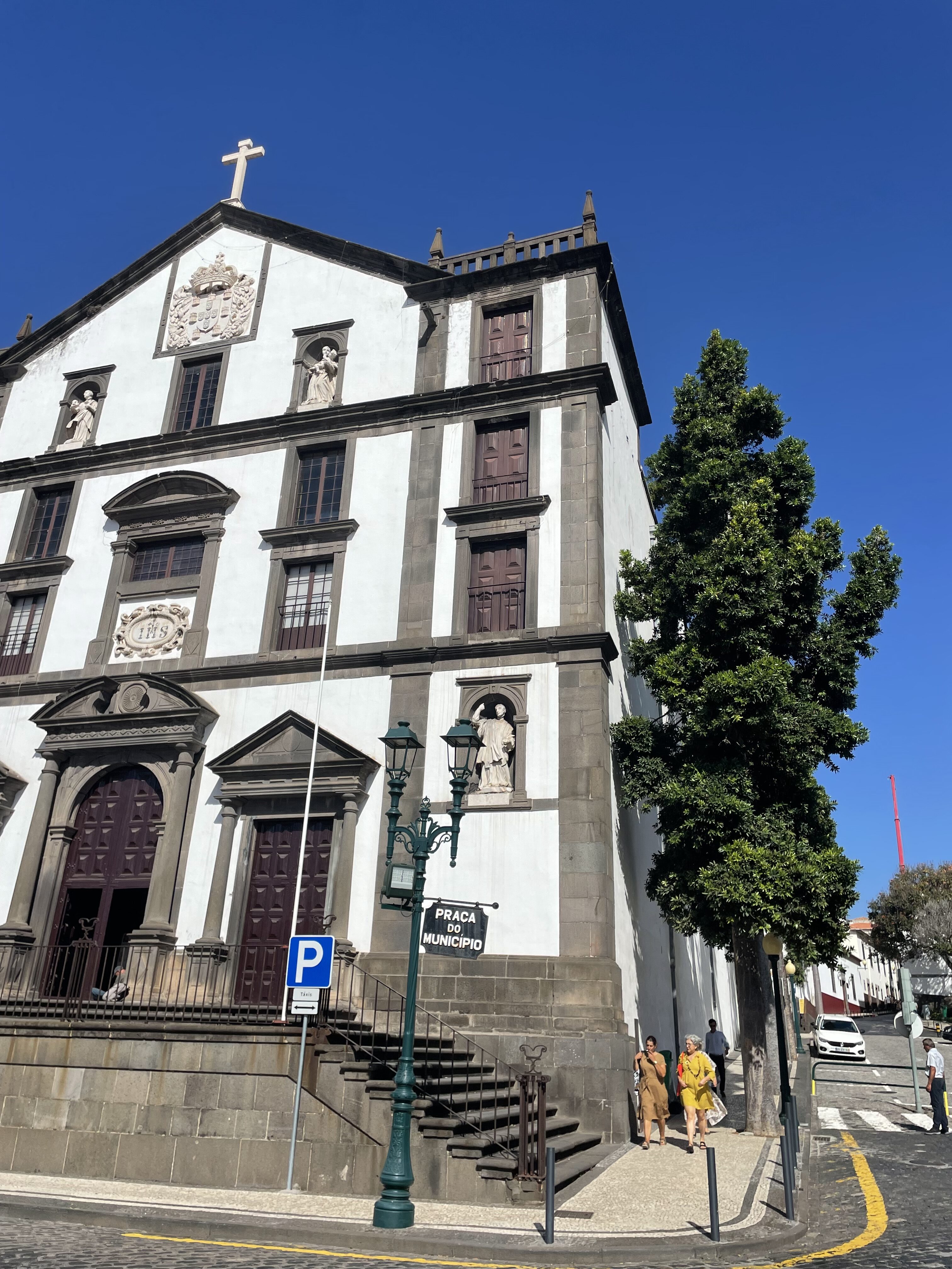 A white and dark grey stone religious building in Funchal Old Town.