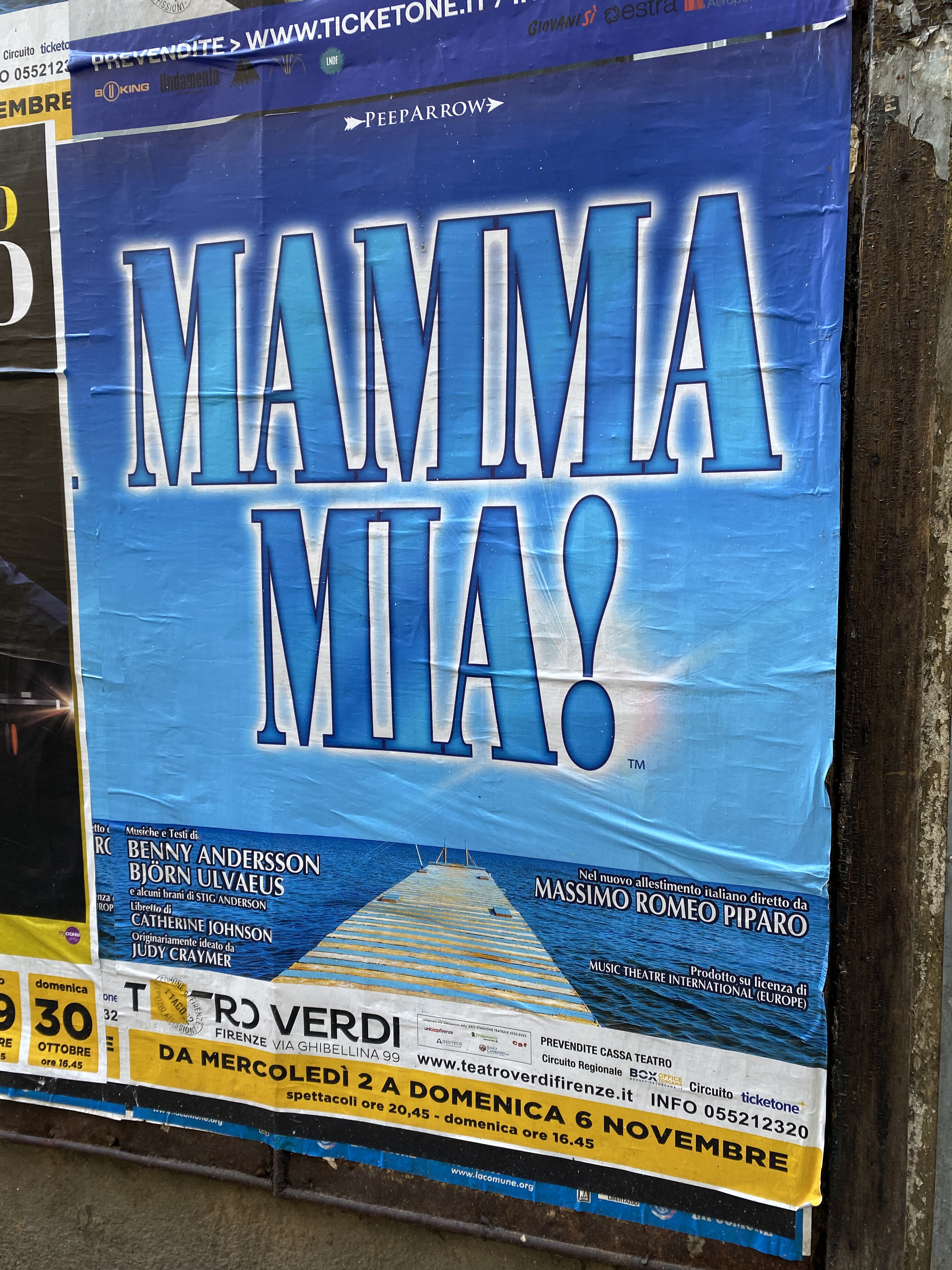 A bright blue poster for the musical performance of "Mamma Mia!" at Teatro Verdi, a local theater in Florence.