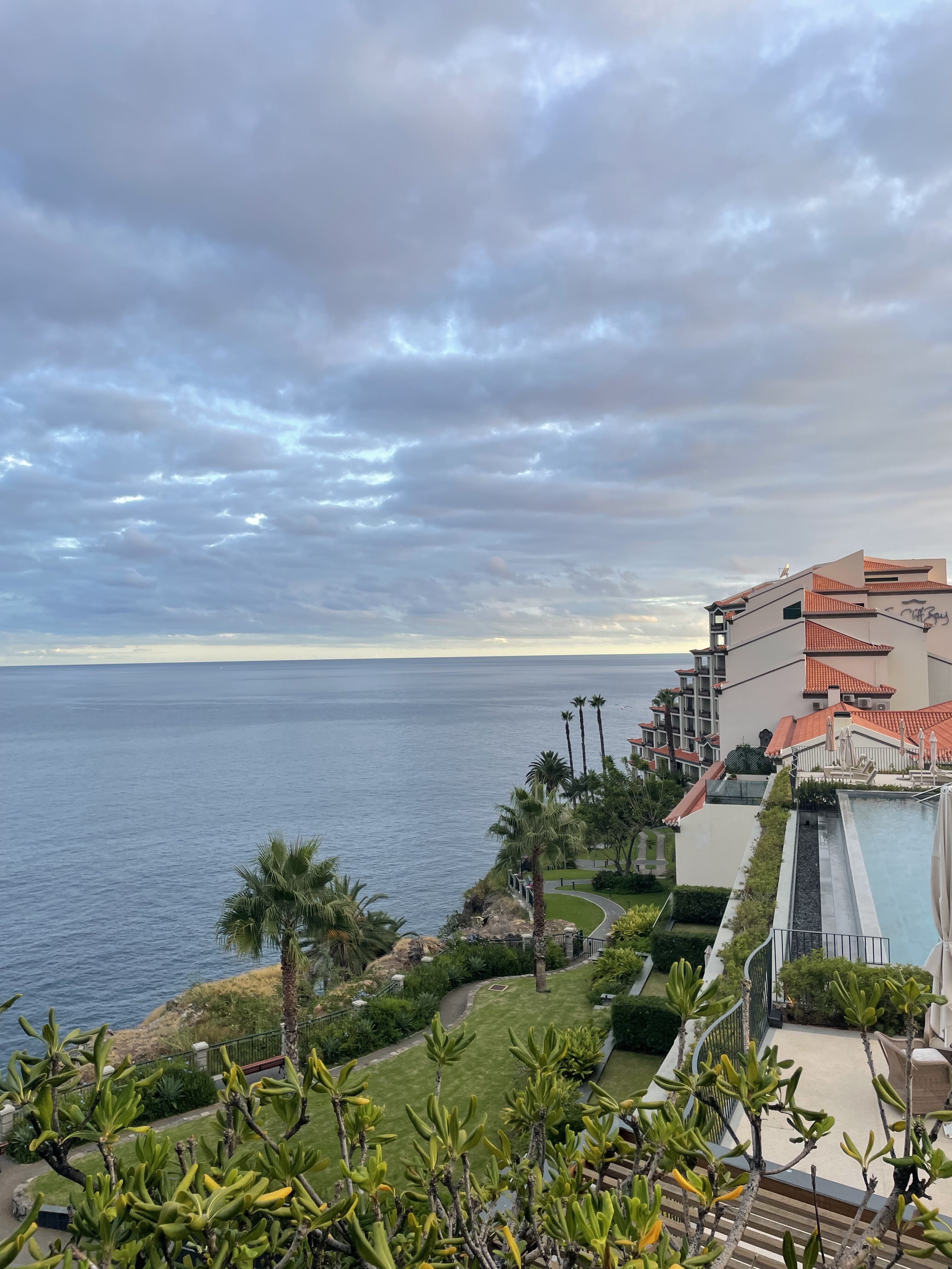An oceanfront view of the North Atlantic Ocean featuring a resort with lots of vibrant greenery.