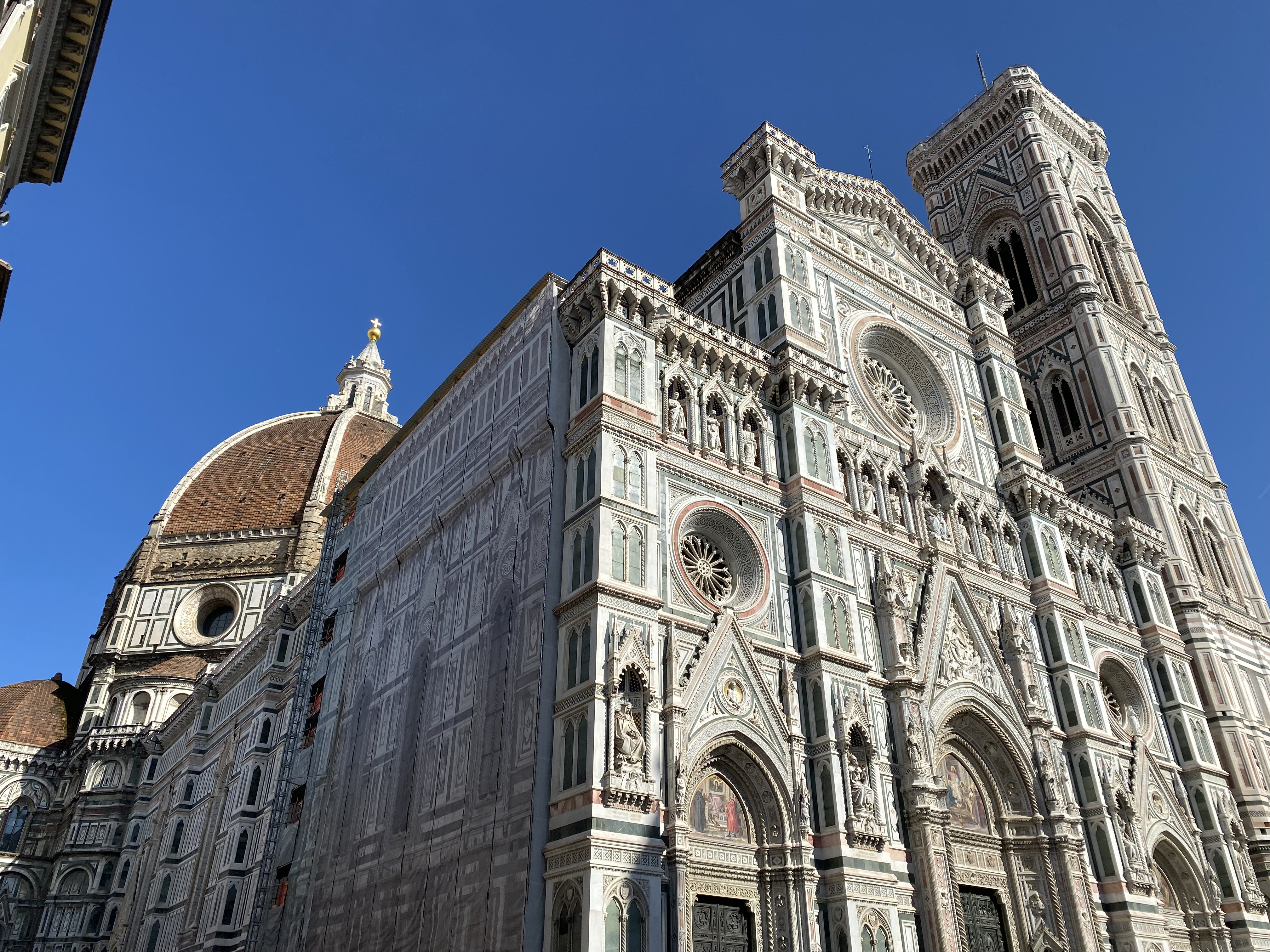 A side profile of the monumental Santa Maria del Fiore in Florence, Italy – one of the best areas to stay in Florence!