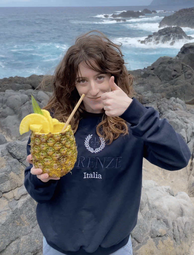 Bella drinking piña colada, right from the source – a pineapple!