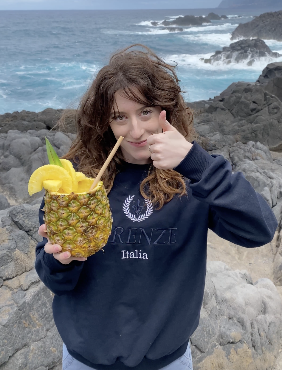 Bella drinking piña colada, right from the source – a pineapple!