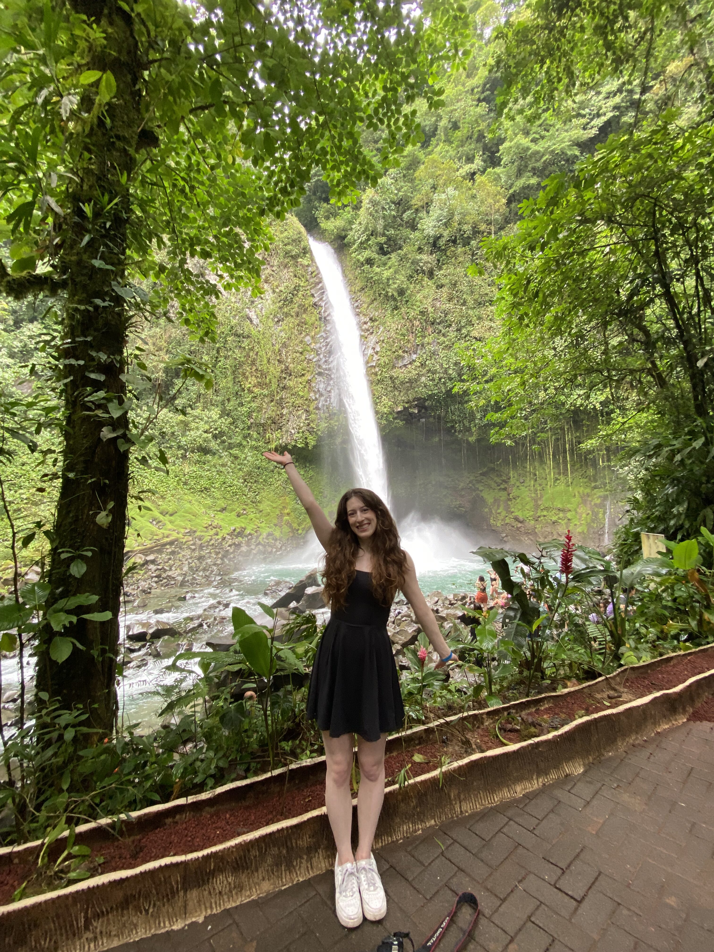 Bella posing in front of La Fortuna Waterfall.