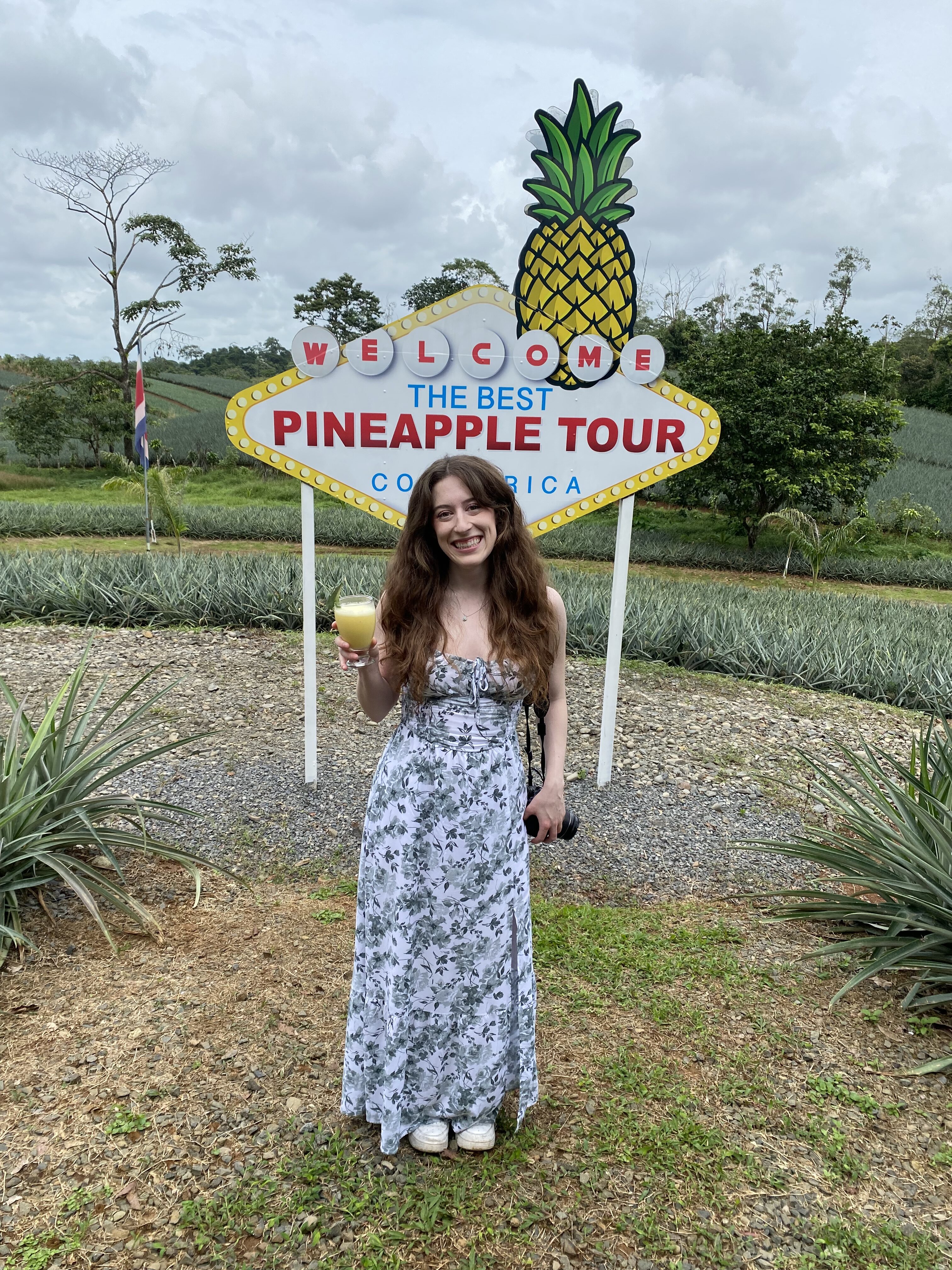 Bella holding a fresh piña colada at "The Best Pineapple Tour".