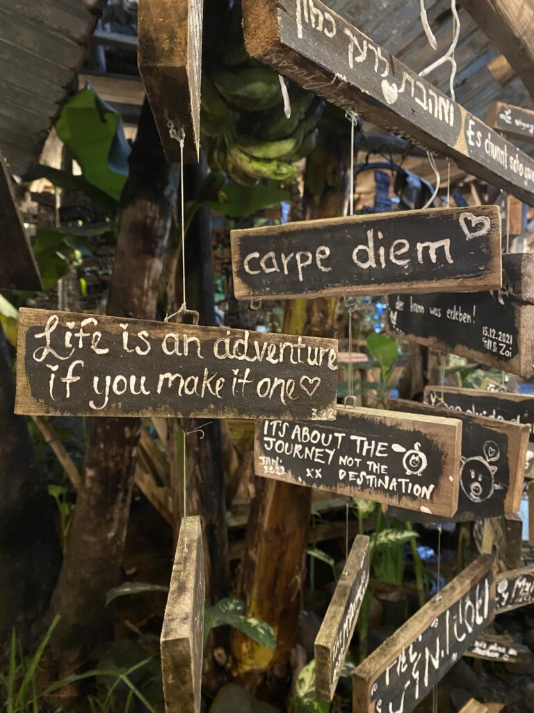 Handpainted signs at a Costa Rican Soda that read, "Carpe Diem", and "Life is an adventure if you make it one".