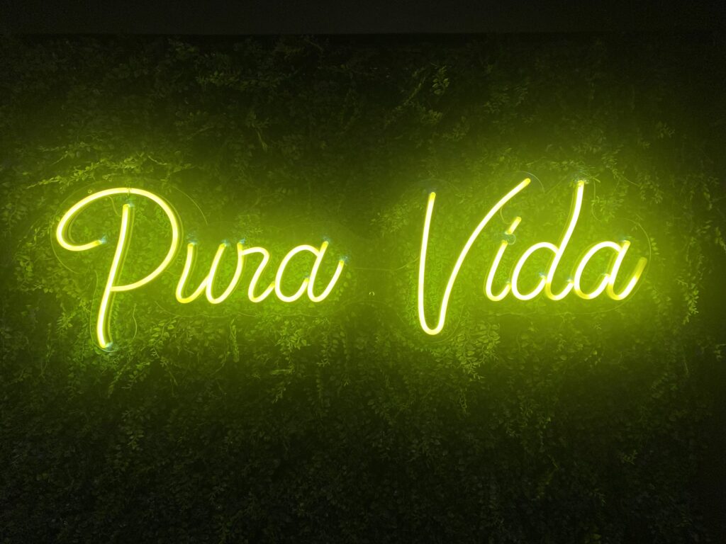 A neon yellow, "Pura Vida" sign.
