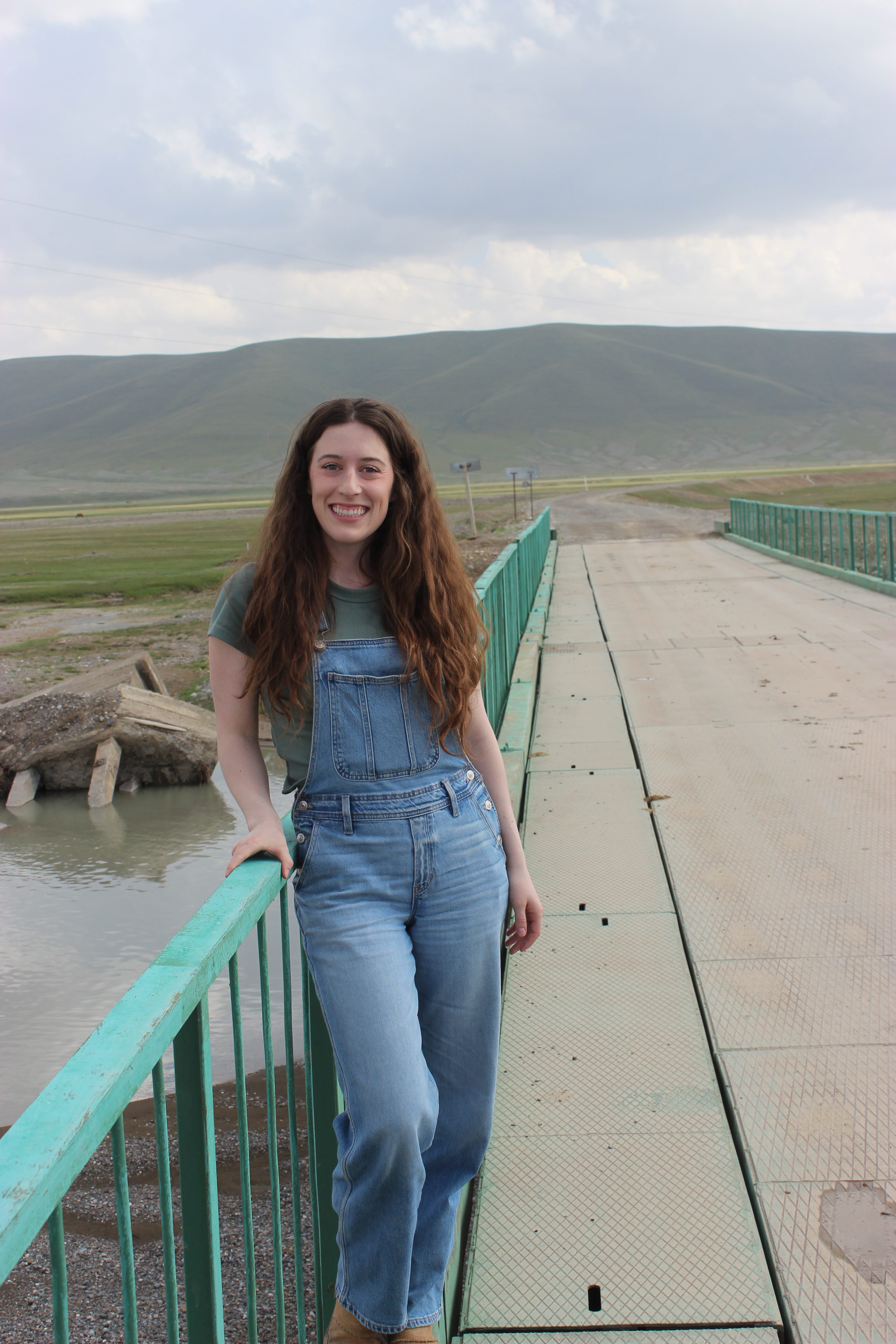 Bella posing on a bridge in Kyrgyzstan.