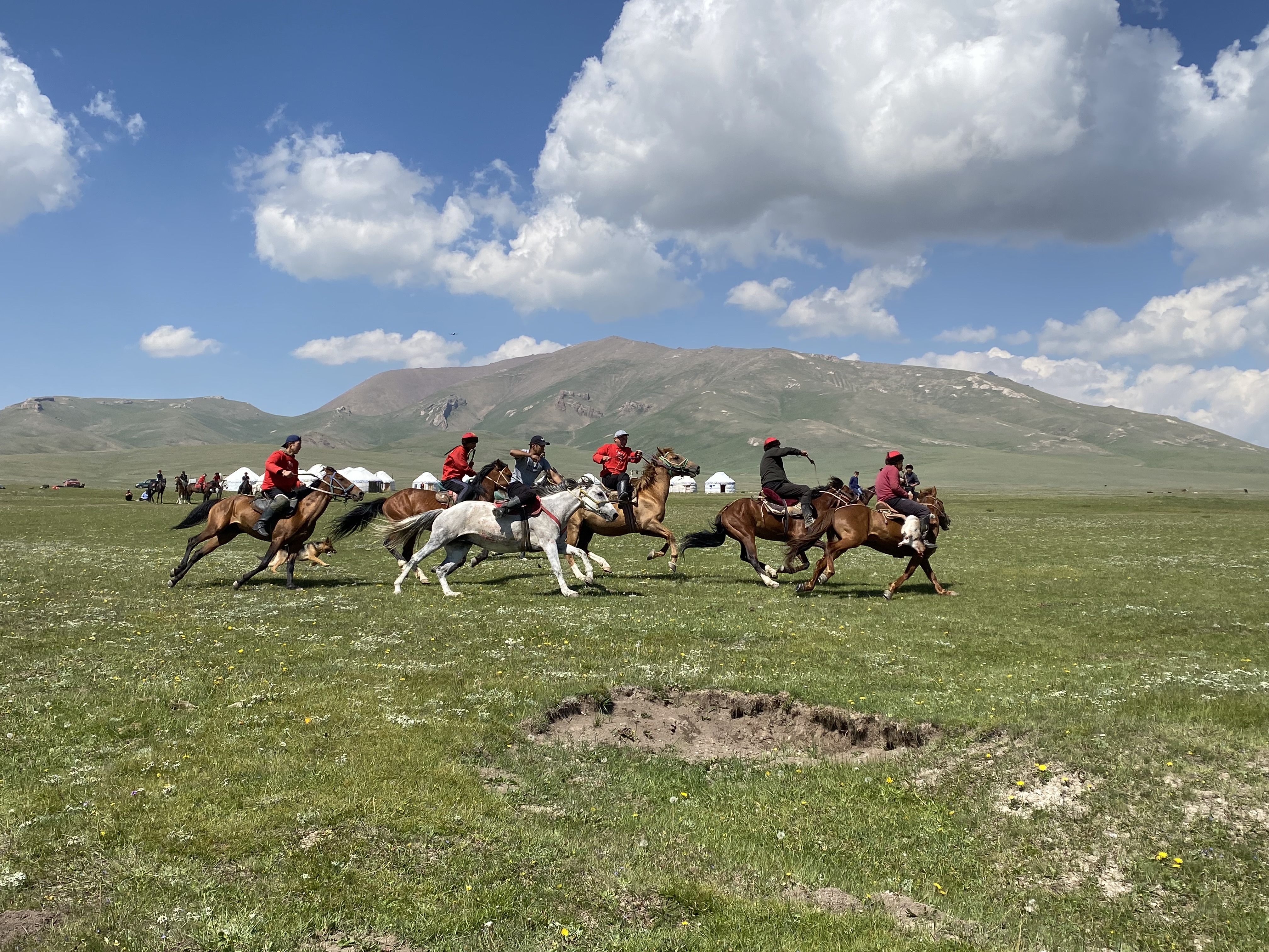 A traditional game of Kok Boru, a game where horseback riders attempt to throw a goat carcass in the opponent's goal.