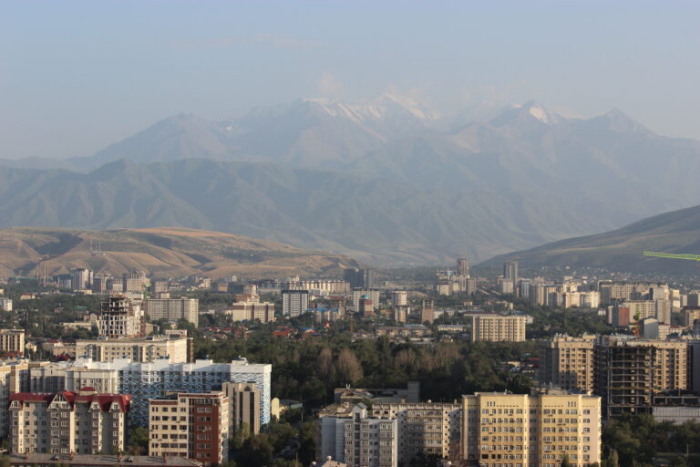 Rooftop view of Bishkek with the mountains in the background.