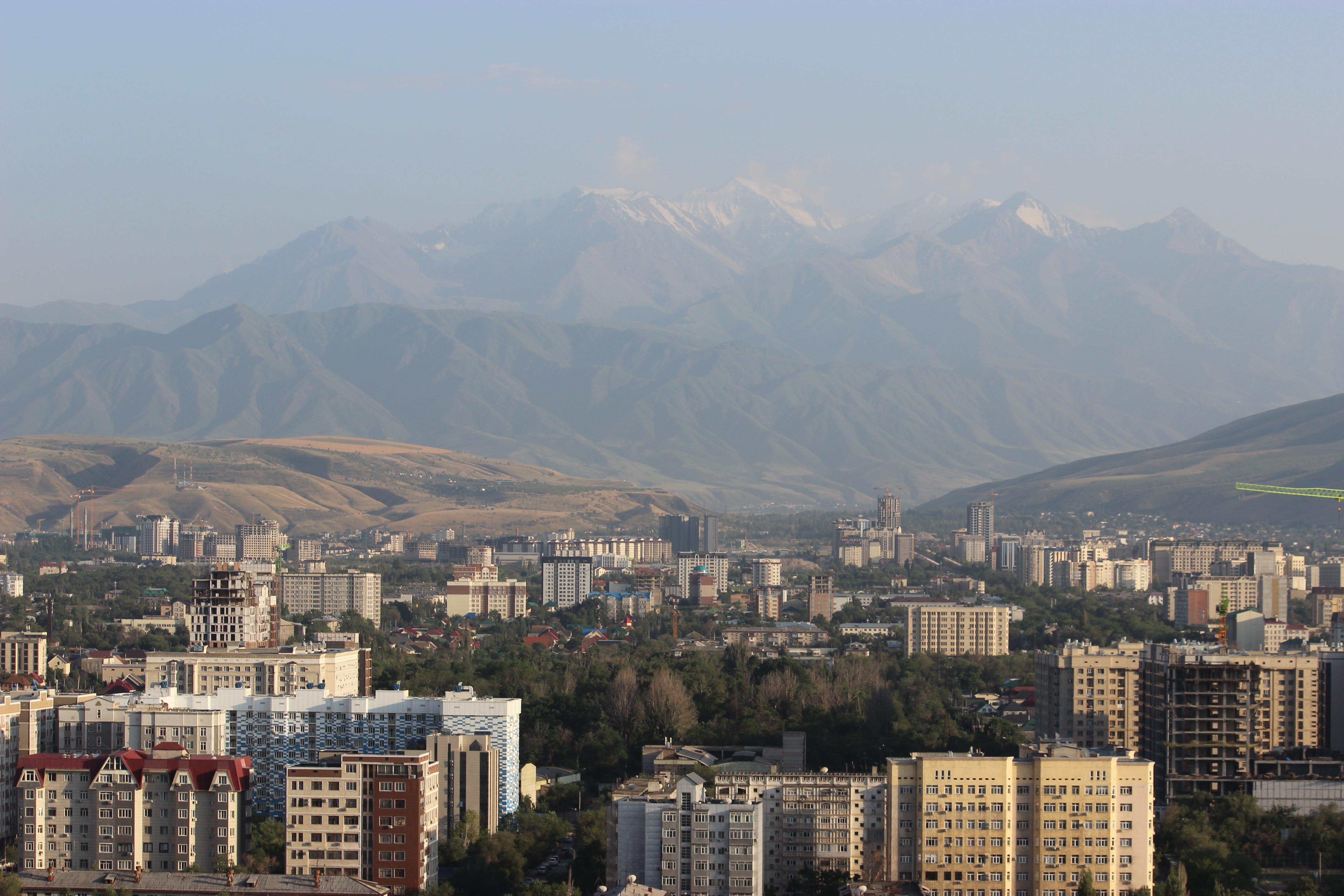 Rooftop view of Bishkek with the mountains in the background.