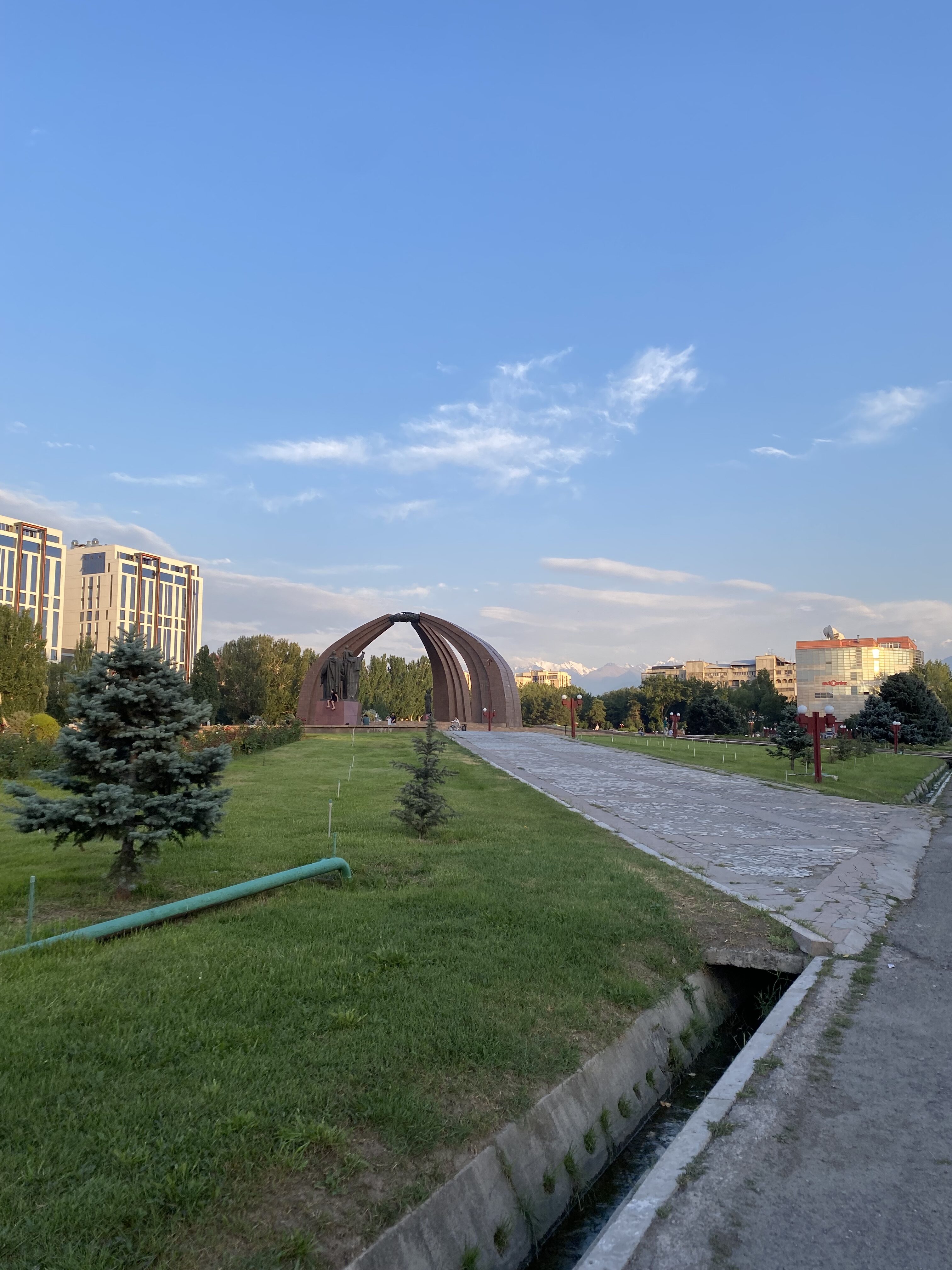 The Victory Monument in Bishkek seen in the middle of a park.