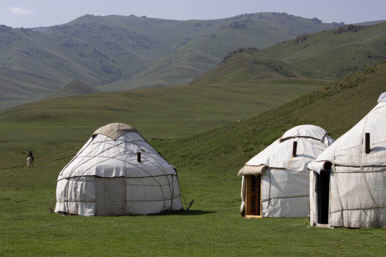 Yurt camp in a grassy area outside of Kyzart village.