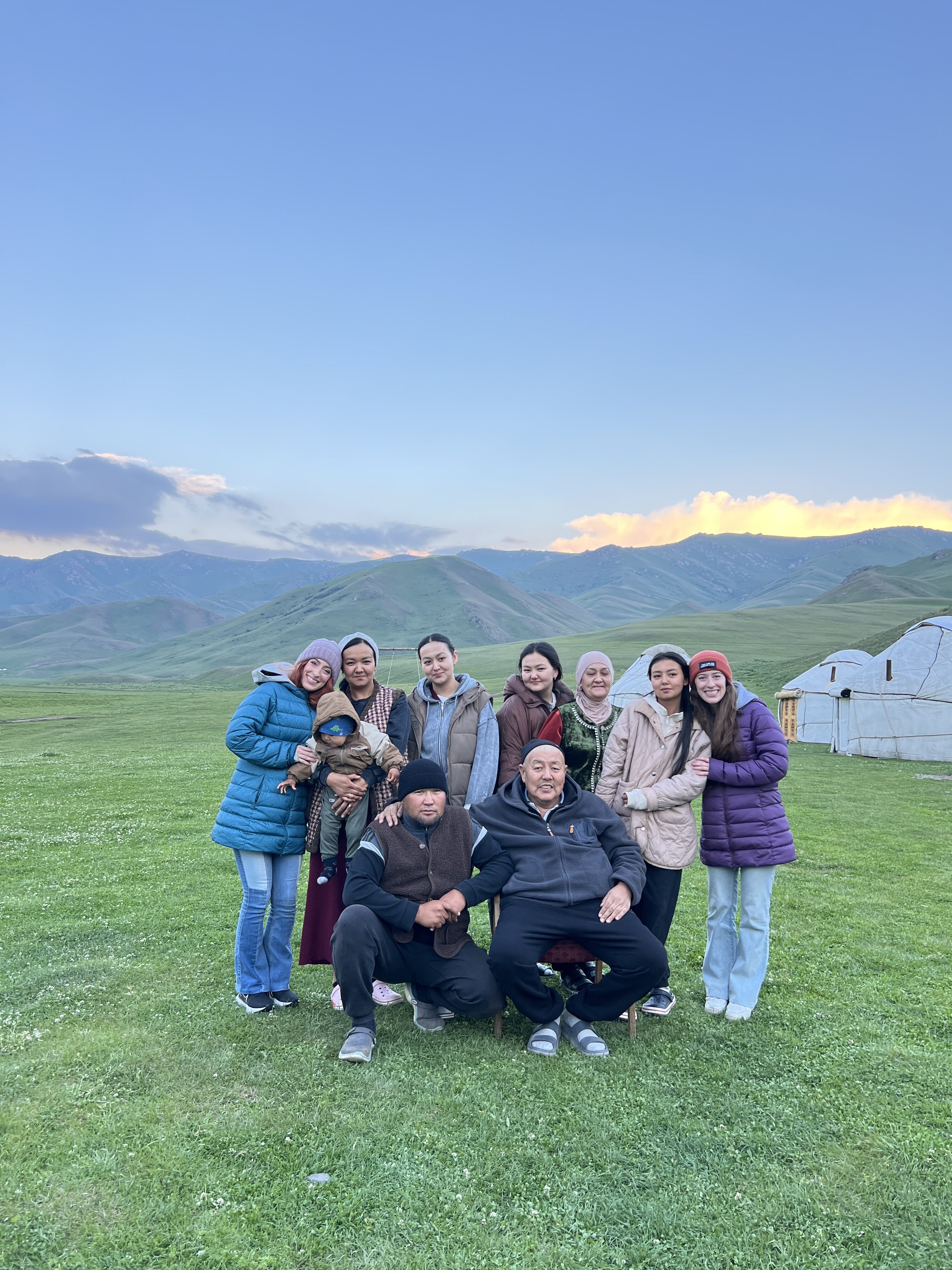Bella and Lily huddled in the local family photo at a yurt camp in Kyrgyzstan.