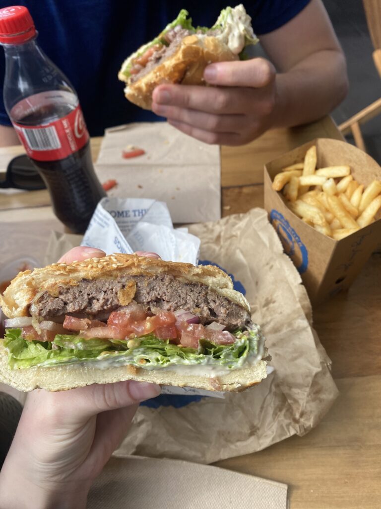 A beautiful burger from Queenstown's Fergburger with a side of fries and a Coke.