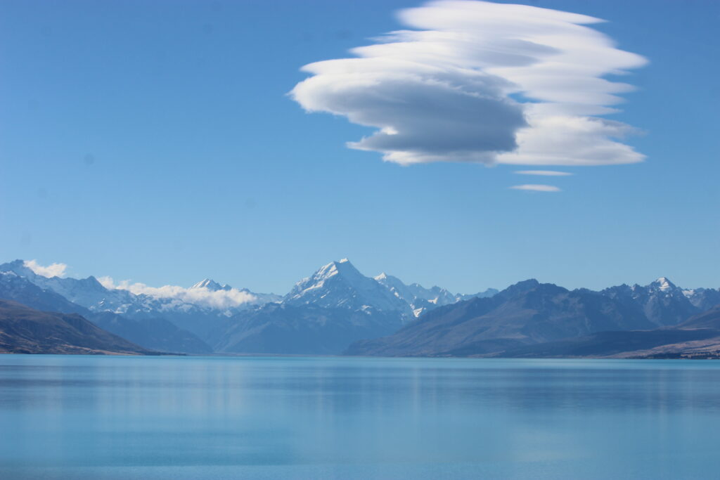 Lake Pukaki under a bright blue sky.