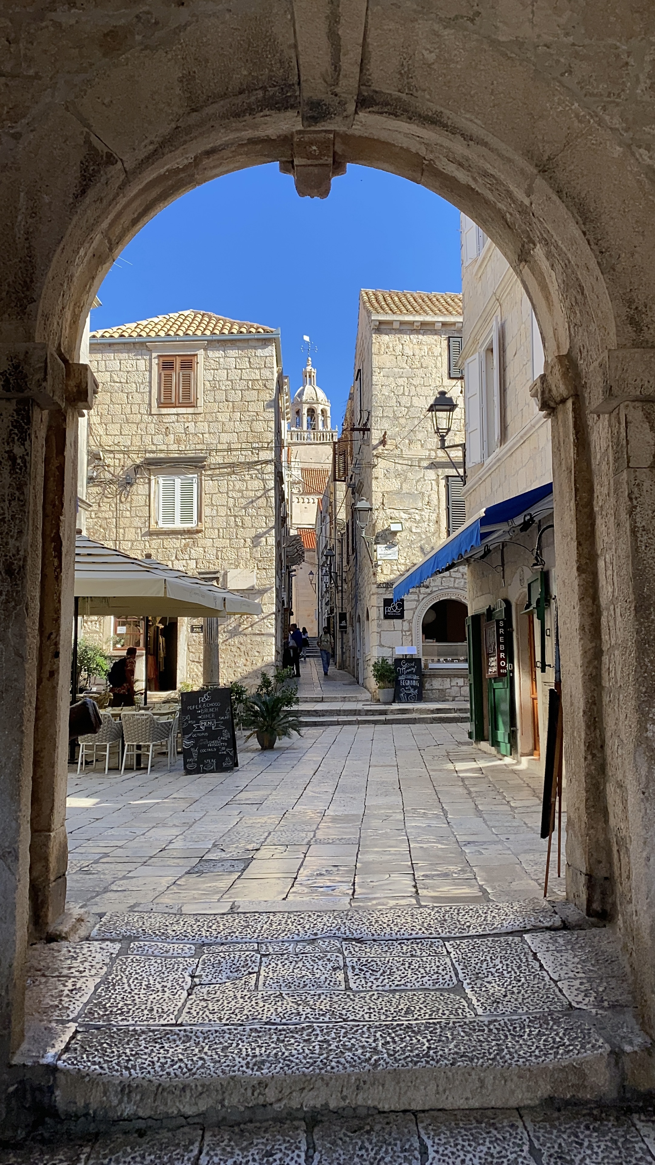 A rounded stone entrance leading to Korčula Old Town.