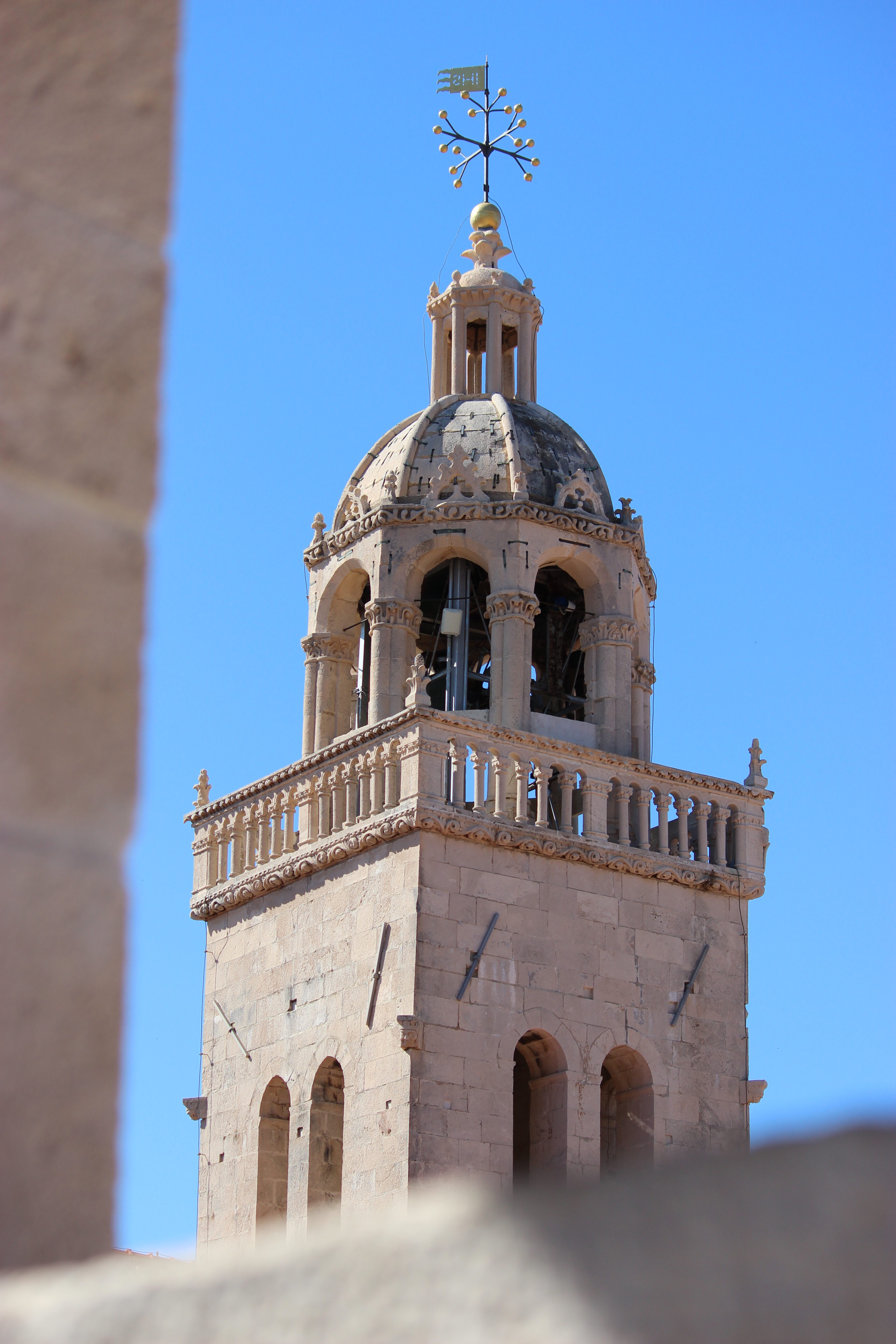 The tan stone bell town of Saint Mark's Cathedral in Korčula Old Town.