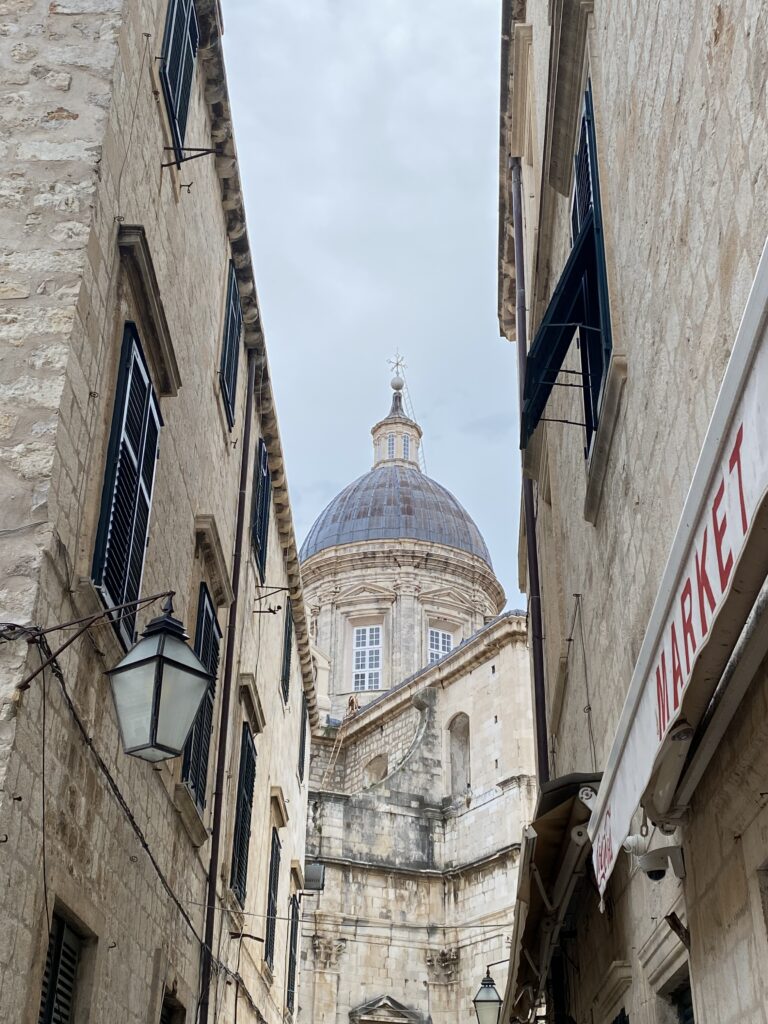 A grey-domed roof in Dubrovnik Old Town surrounded by narrow stone buildings.