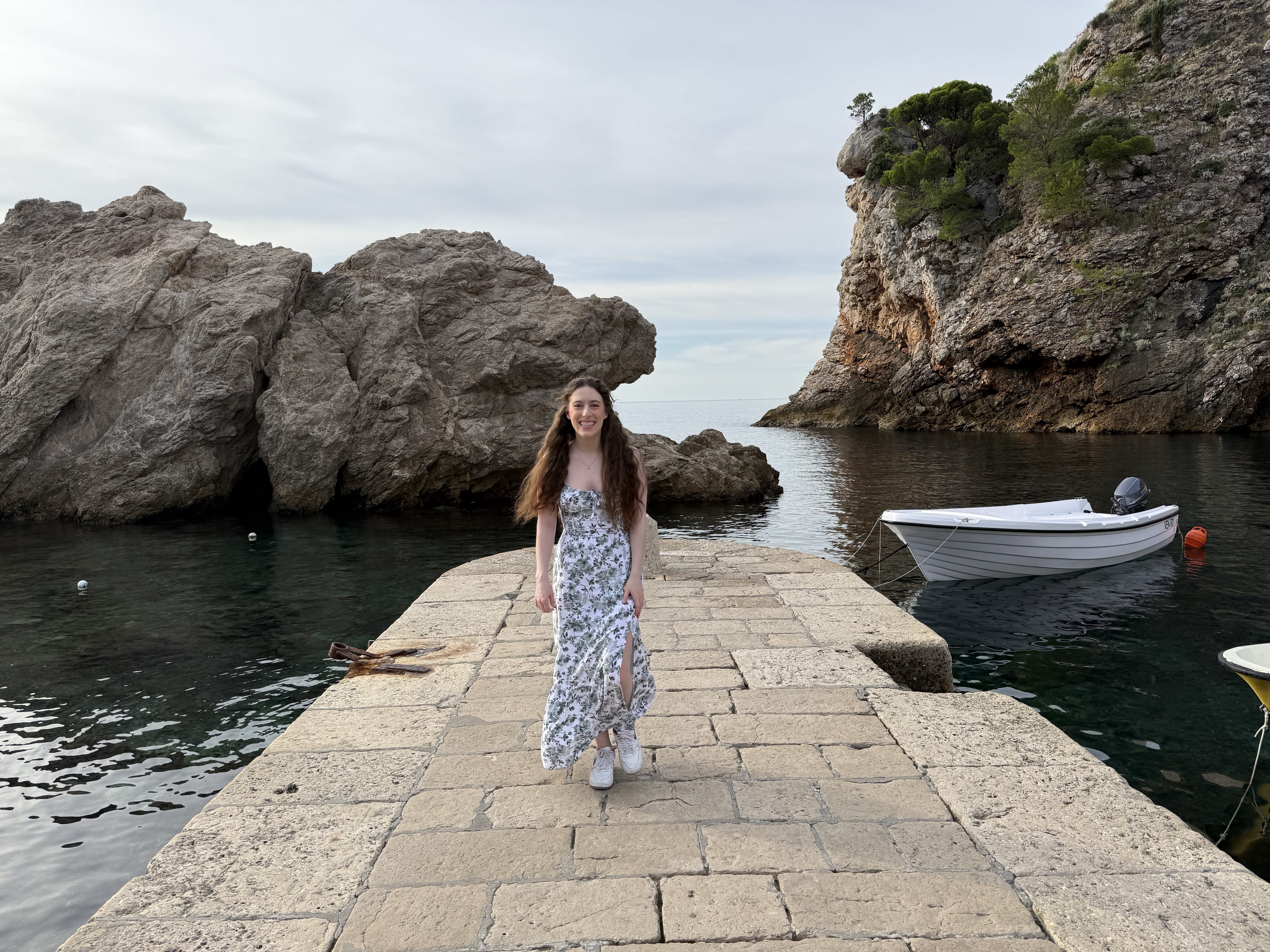 Bella walking along the stone pier at Dubrovnik West Harbor.