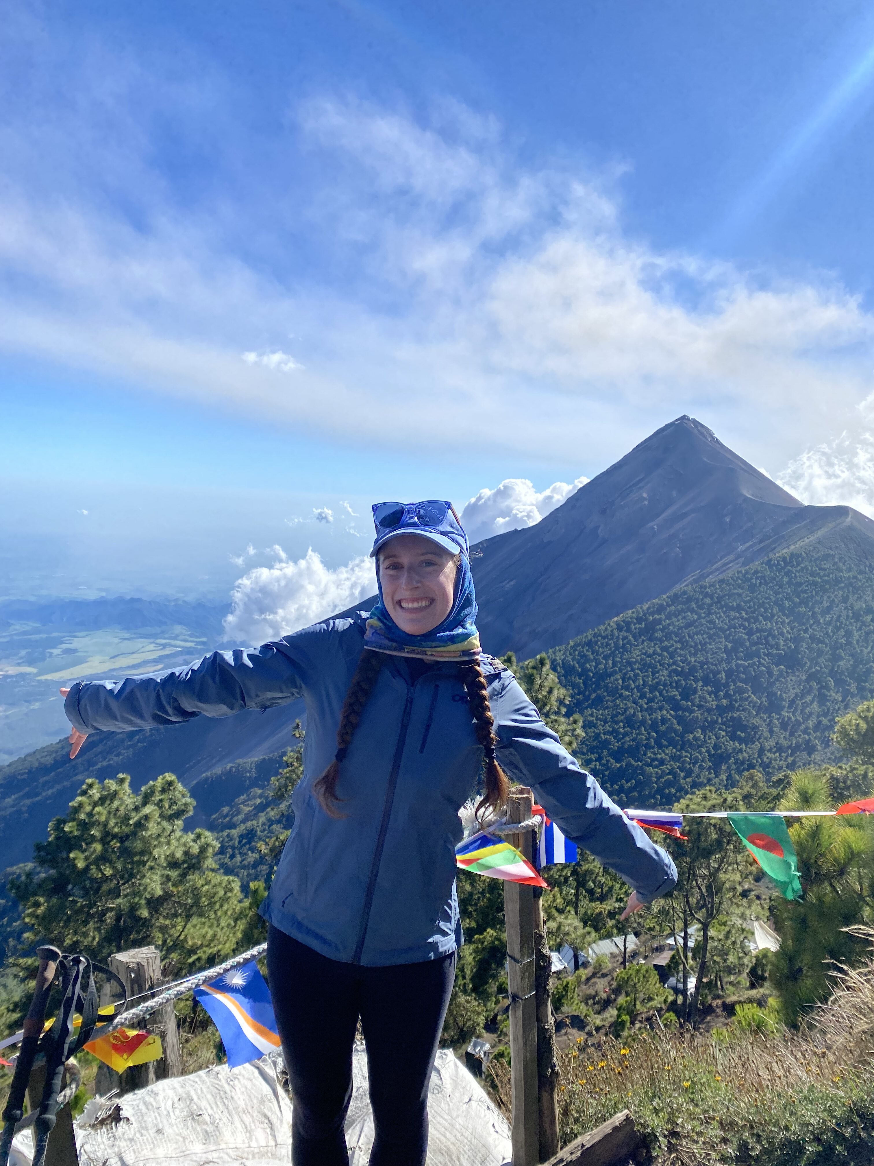 Bella smiling from Acatenango base camp in front of Fuego Volcano.