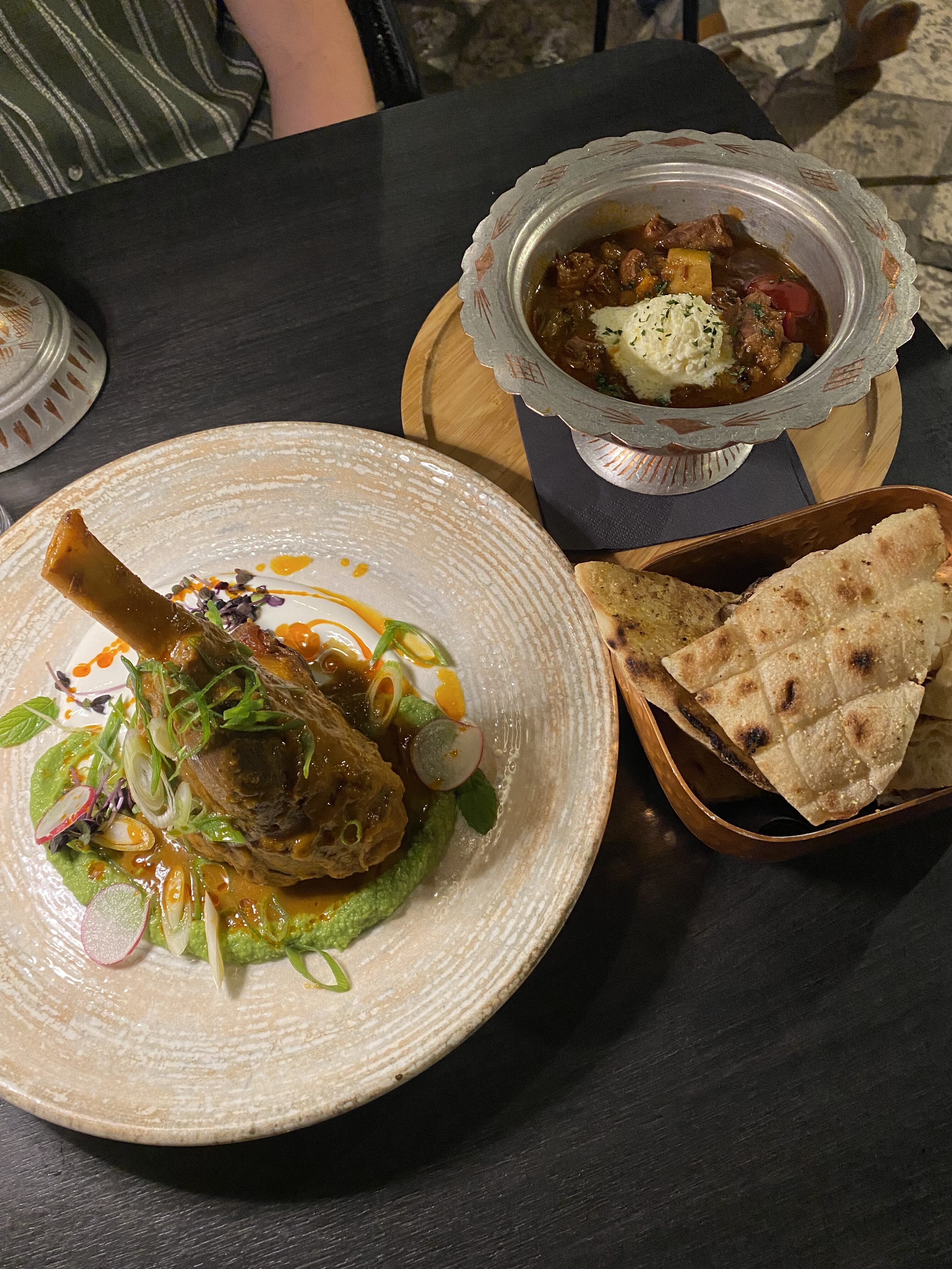 Slow-raosted lamb on a pea sauce and kebabs in a silver bowl with thin bread from Taj Mahal Dubrovnik.