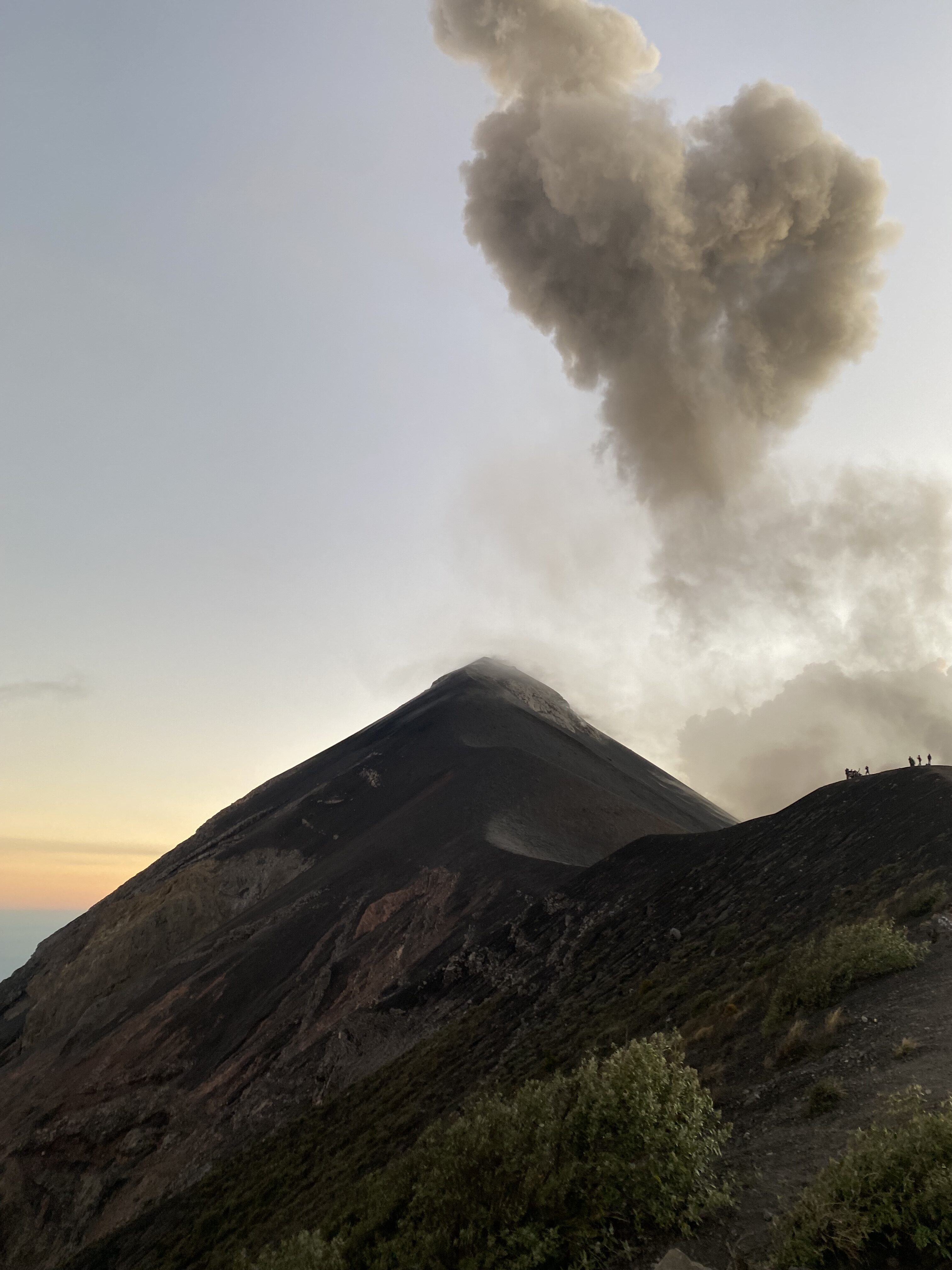 Heart-shaped silver smoke over Fuego Volcano in Guatemala as the sun sets.