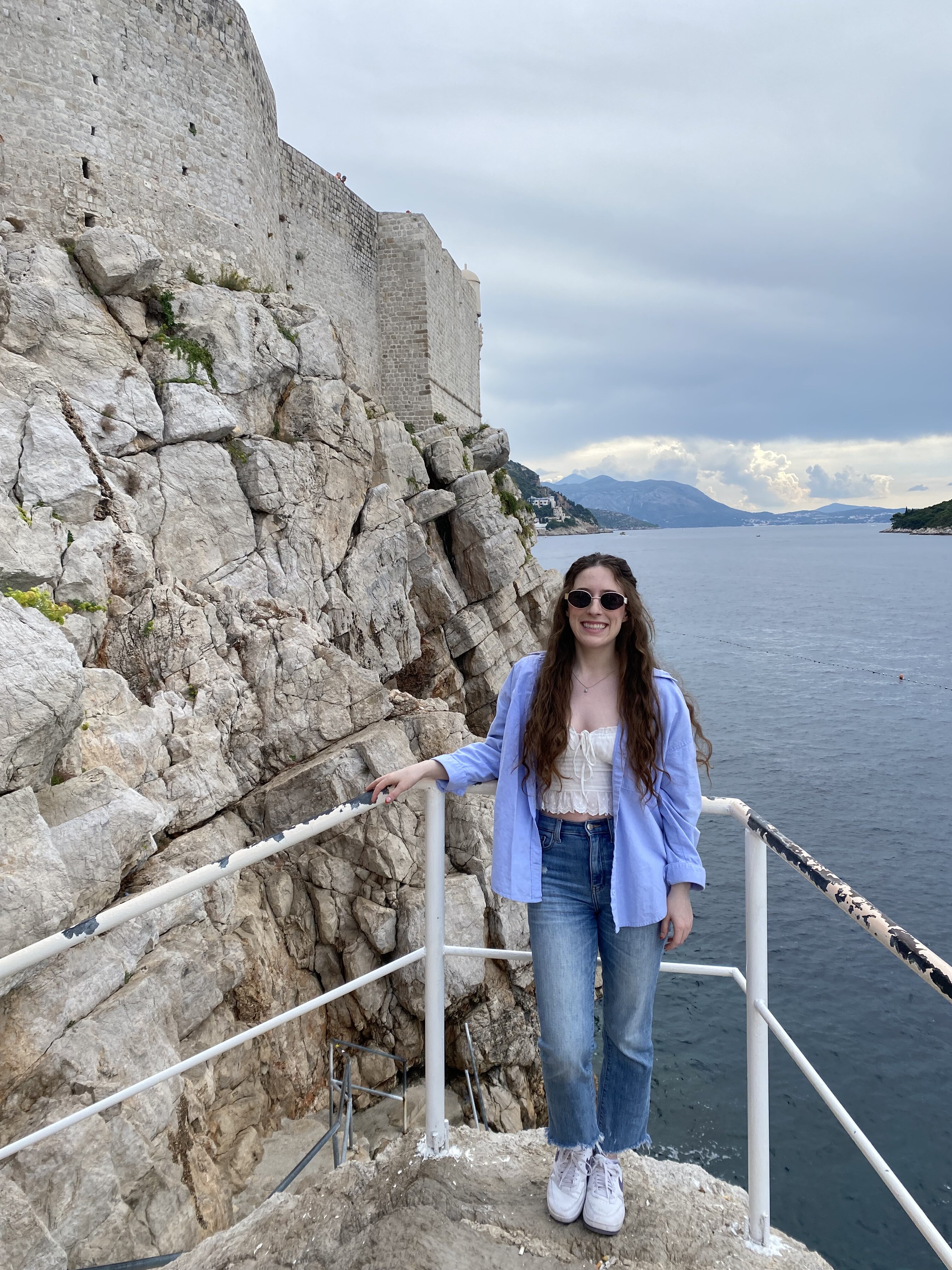 Bella, smiling at Buža bar in Dubrovnik.