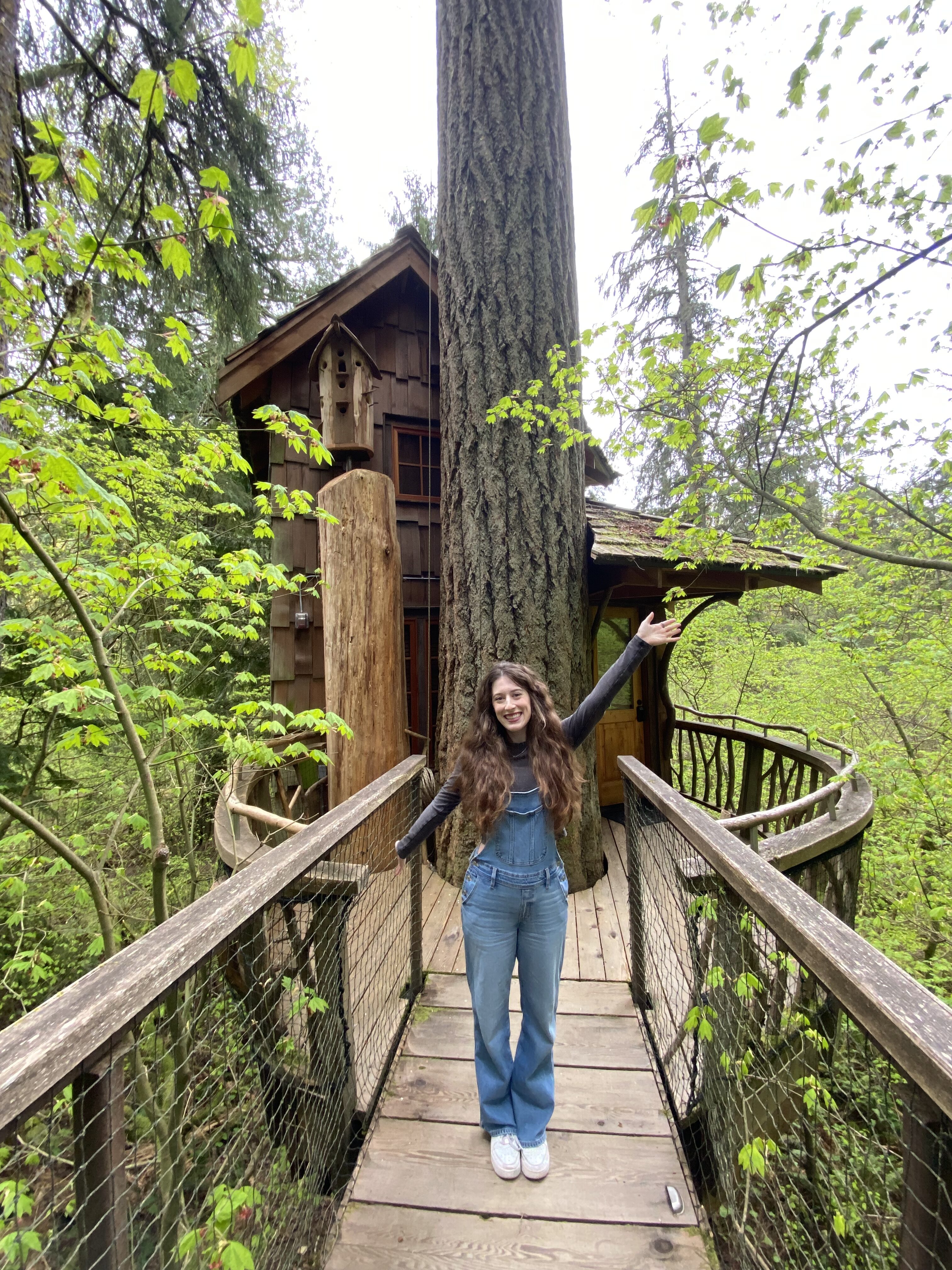 Bella posing in front of Burl Treehouse at Treehouse Point in Issaquah, Washington.