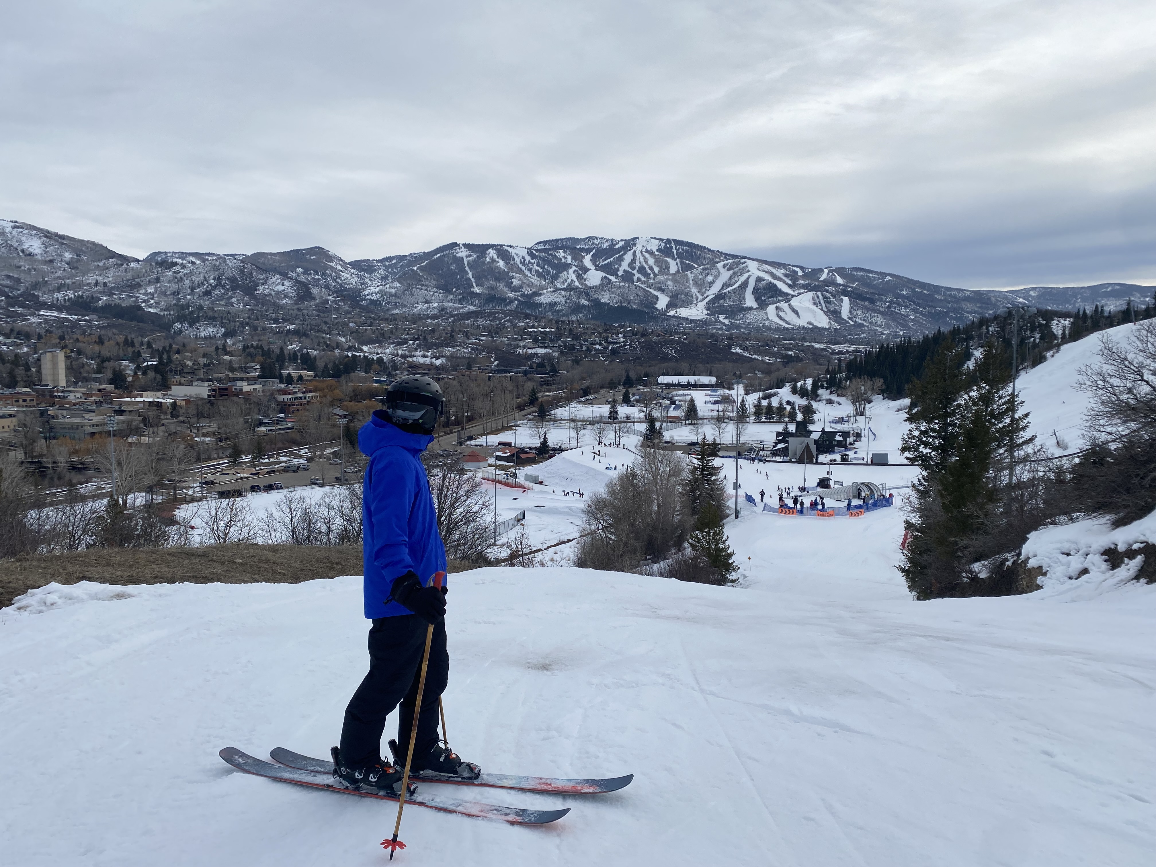 Skier at Howelsen Hill, looking at Steamboat Ski Resort in the distance.