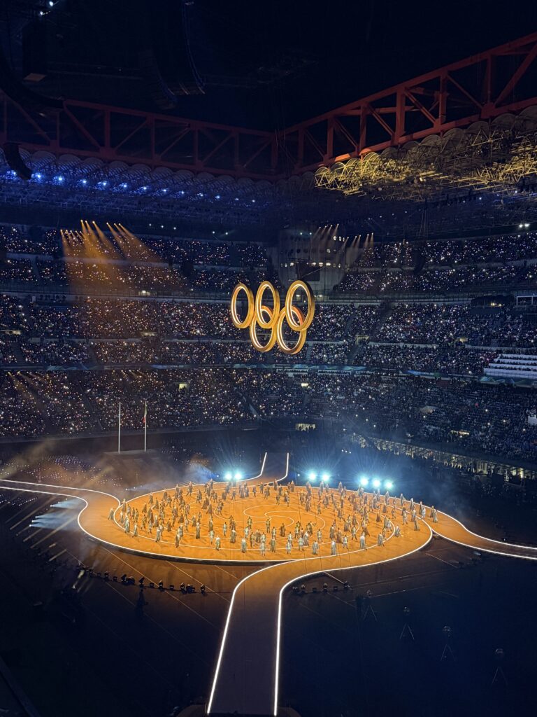 Gold Olympic rings and gold stage Milano-Cortina 2026 opening ceremony.