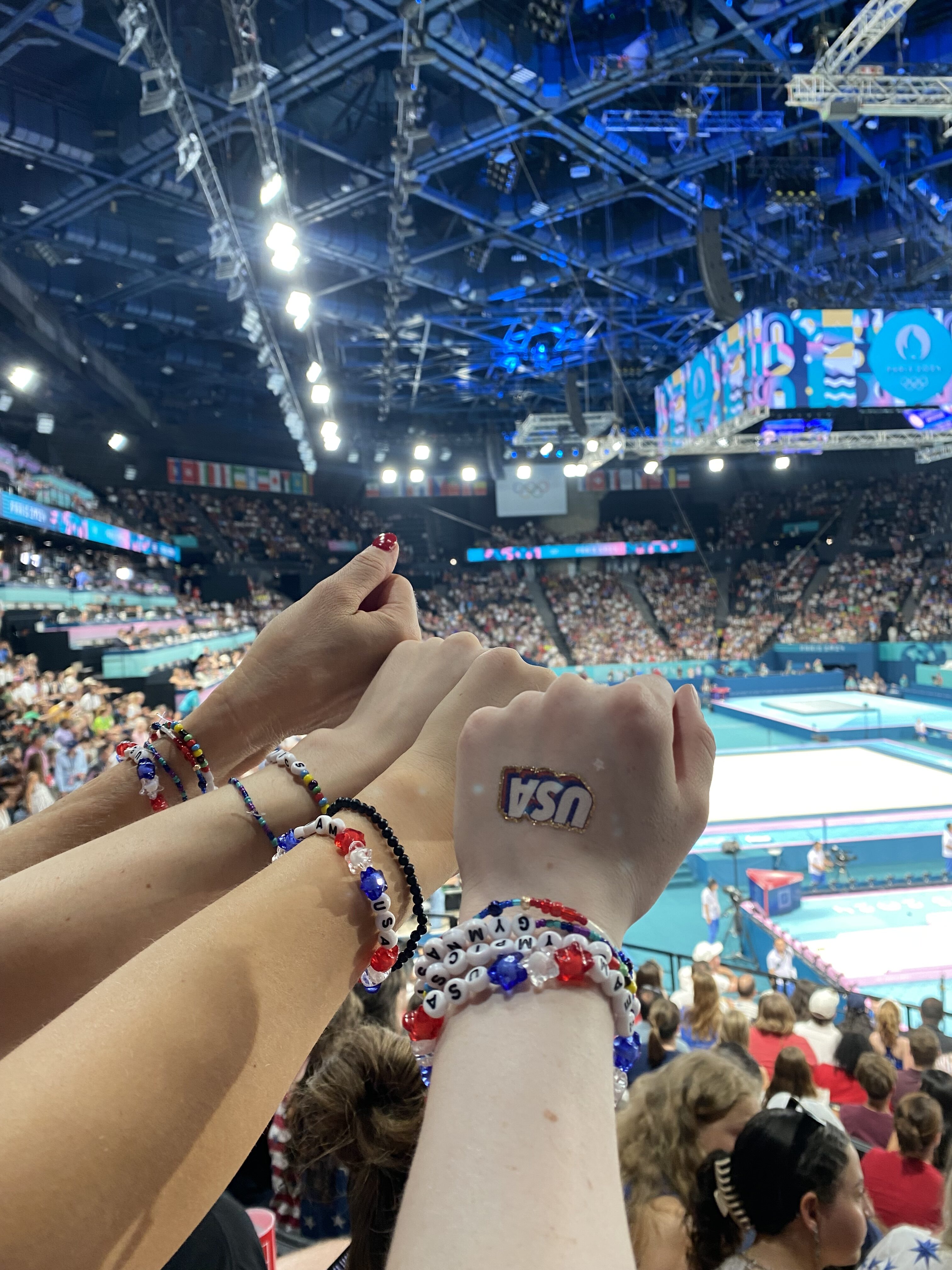 Team USA friendship bracelets and tattoos adorn the hands of fans at the 2024 Paris Olympics.