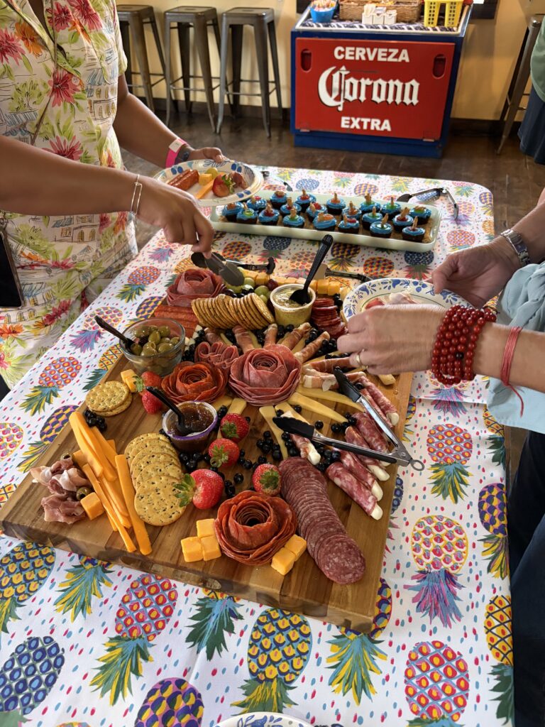 A charcuterie board on a pineapple table cover at Adventures Unlimited.