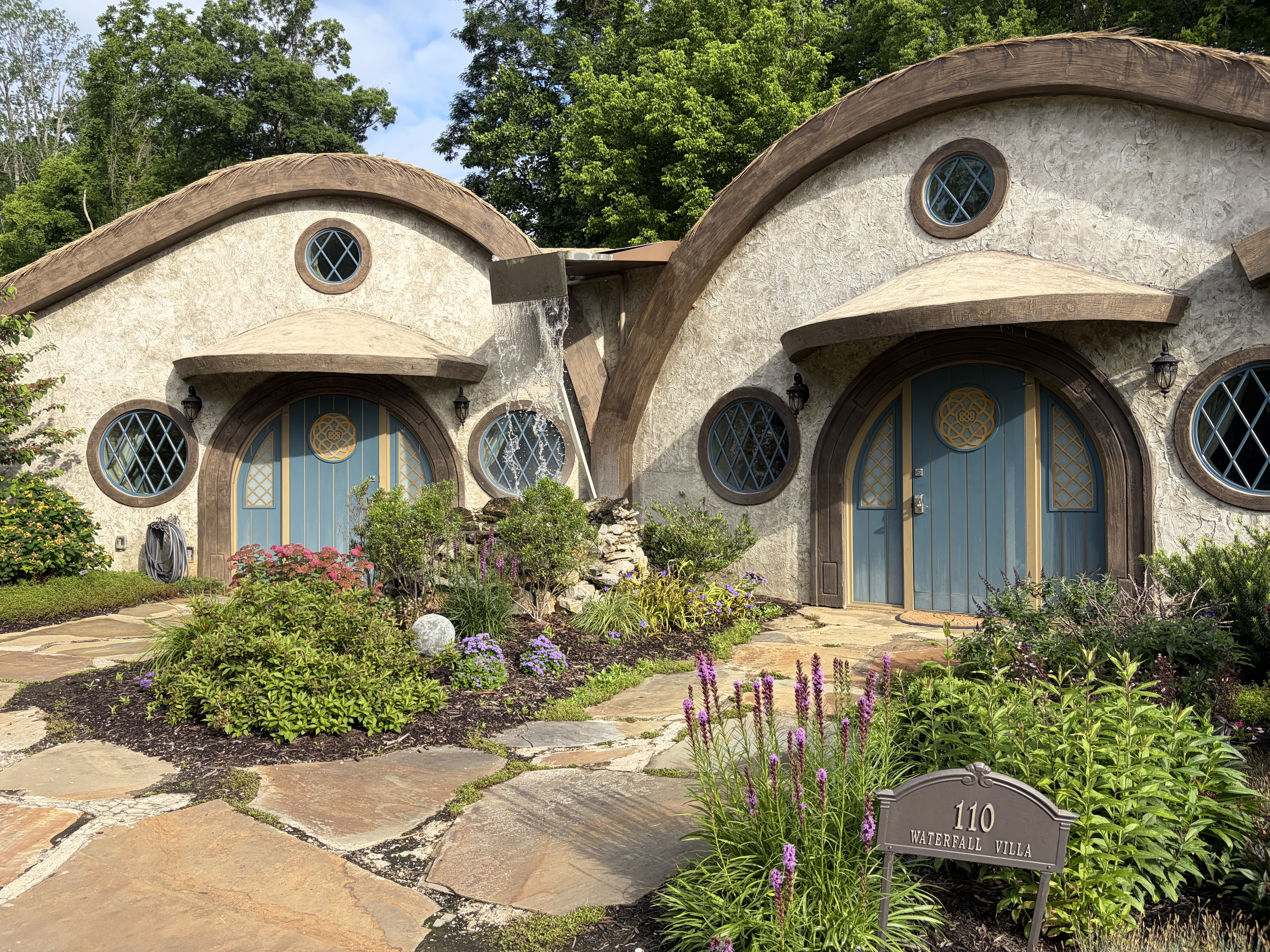 A pair of round bungalows with blue roofs at the Ancient Lore Village.