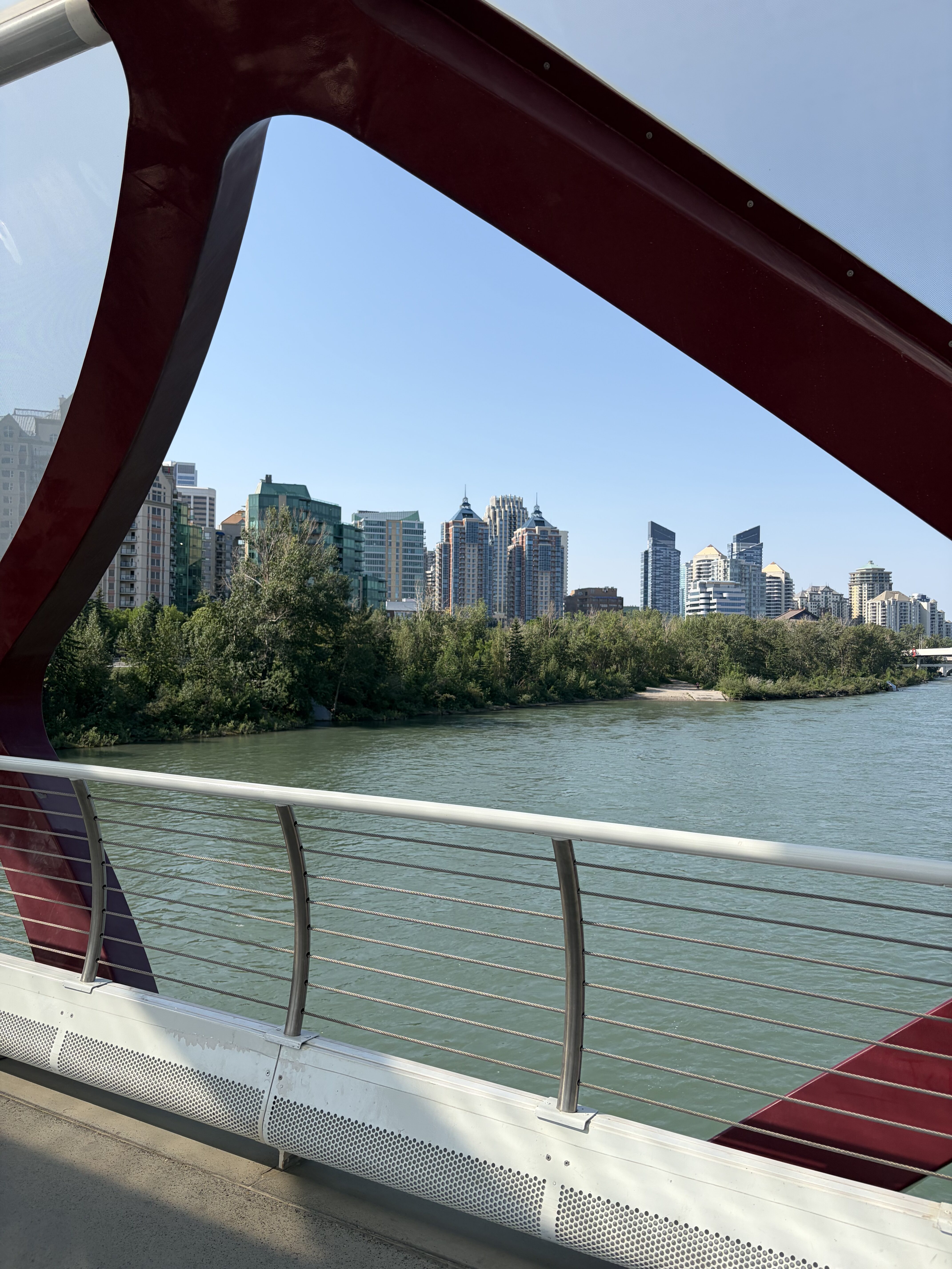 The skyline of Calgary viewed from the diamond-shaped "window" in the Peace Bridge with the Bow River.